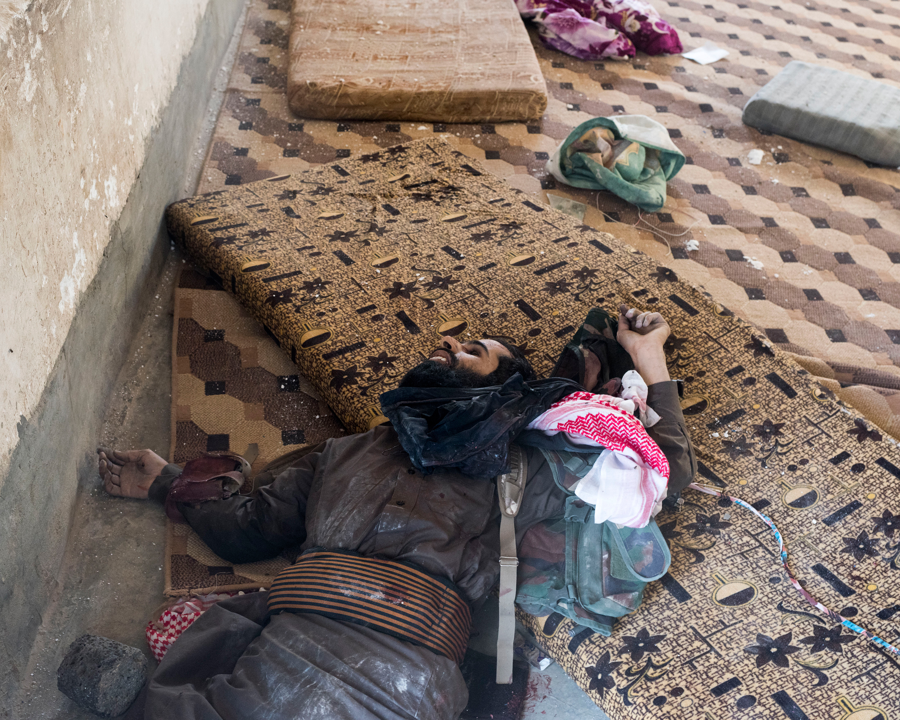 The body of an ISIS fighter killed during fighting with a Kurdish militia on the outskirts of Deir ez-Zor in October. He is still wearing a suicide belt. (Lorenzo Meloni—Magnum Photos)