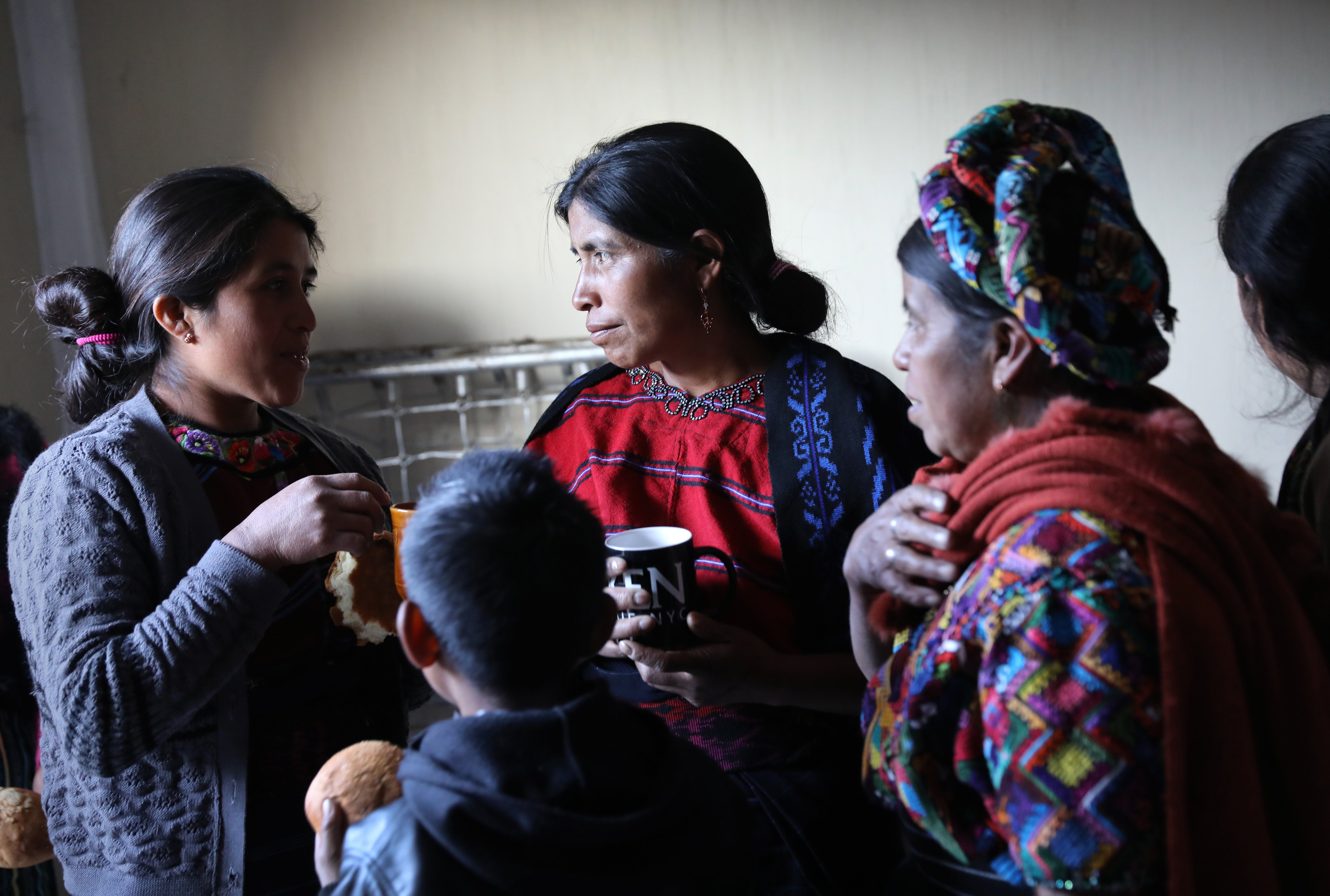 Indigenous Mayan Mam-speaking women drink coffee after a group meeting on February 12, 2017 in Cajola, Guatemala. Women are especially affected by emigration. In Cajola, in the highlands of western Guatemala, some 70 percent of the men have emigrated to the United States to work, many leaving behind wives and children who barely know their fathers. (John Moore—Getty Images)