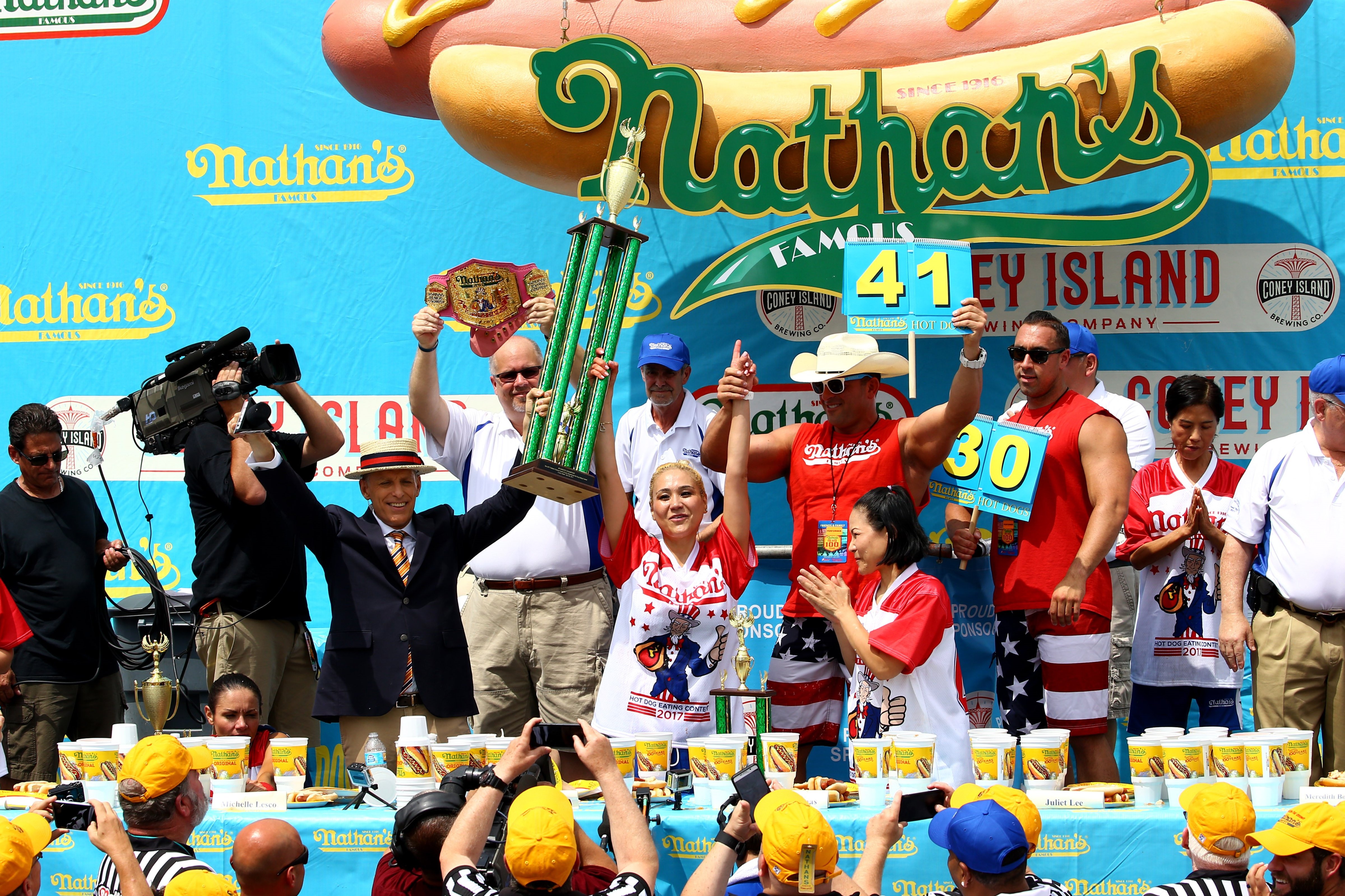 Miki Sudo (center) receives her award after the 2017 Nathan's Famous International Hot Dog Eating Contest (Getty Images)