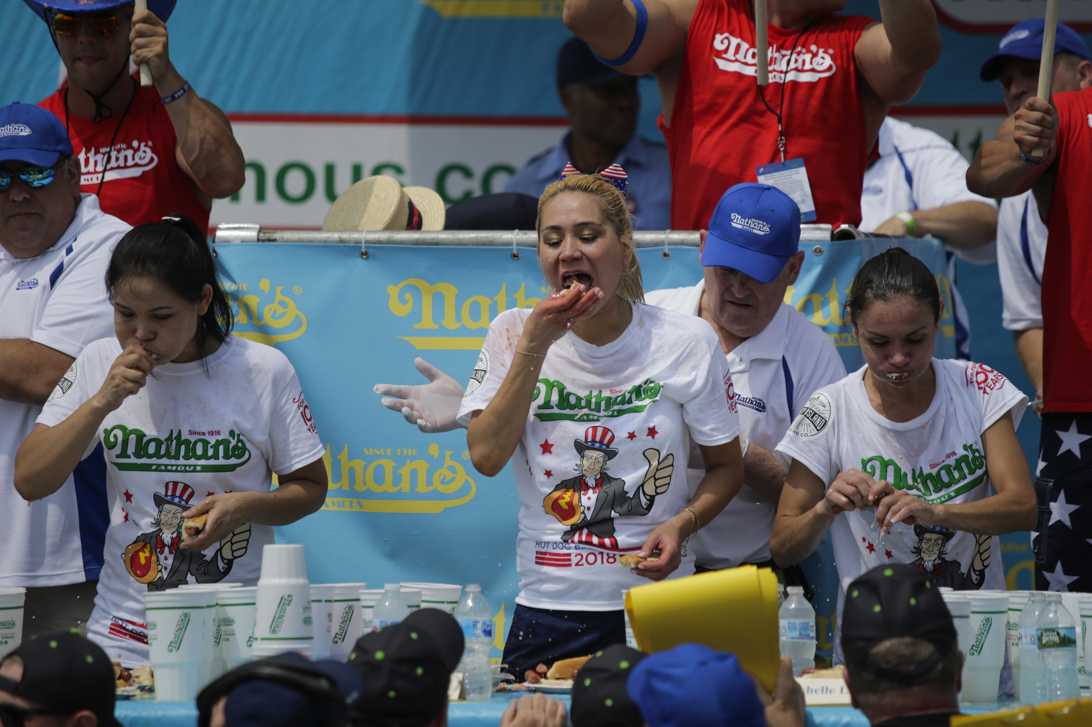 Winner Miki Sudo (C) competes in the women's annual Nathan's Hot Dog Eating Contest on July 4, 2018 in the Coney Island neighborhood of the Brooklyn borough of New York City. Sudo has won the contest 5 years in a row. (Eduardo Munoz Alvarez – Getty Images)