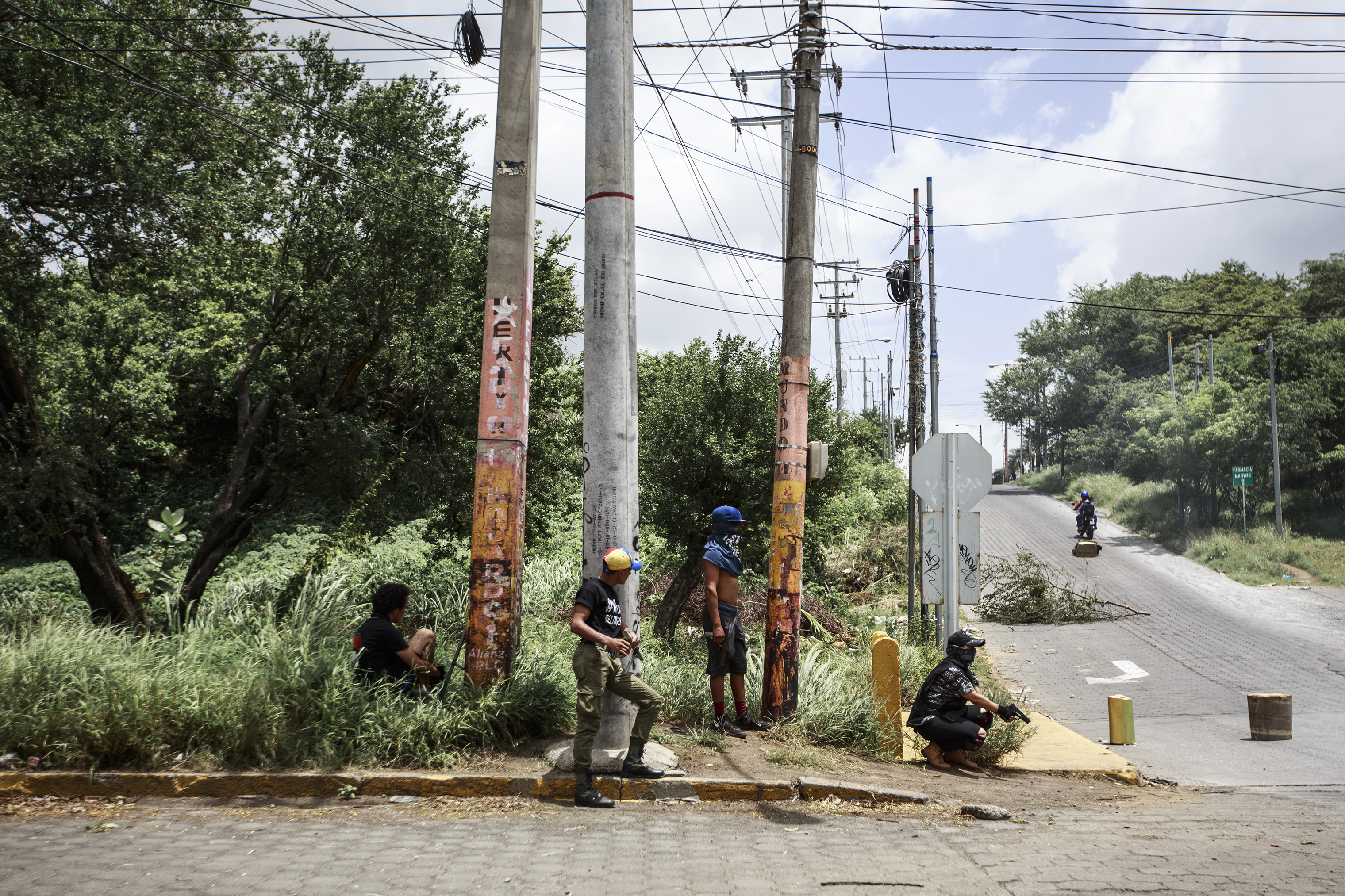 Armed students stand guard near the National Autonomous University of Managua on June 30. (Fred Ramos—El Faro)