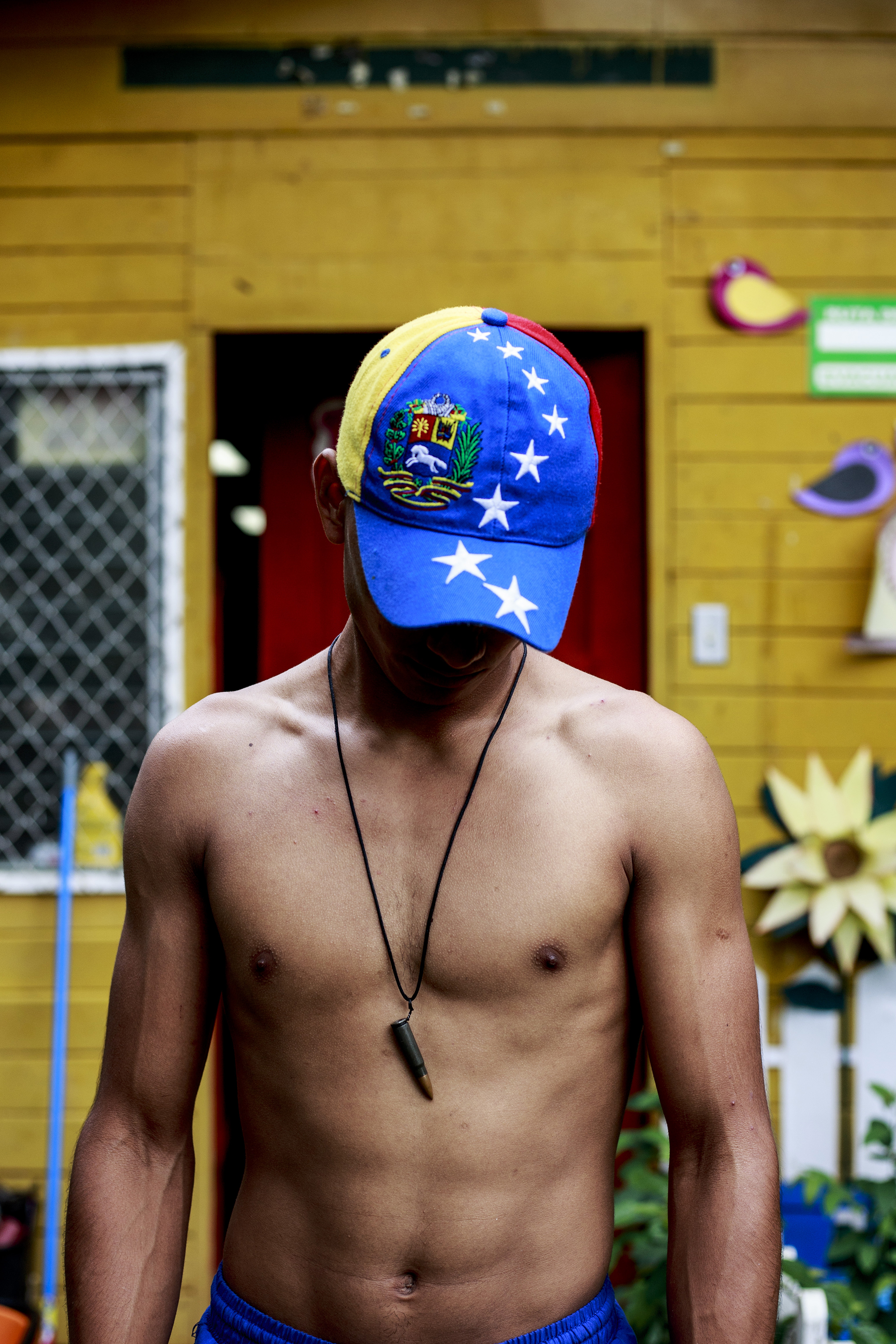 A Venezuelan man participating in the various anti-government protests in Managua on June 27. An AK-47 bullet hangs from his neck. (Fred Ramos—El Faro)