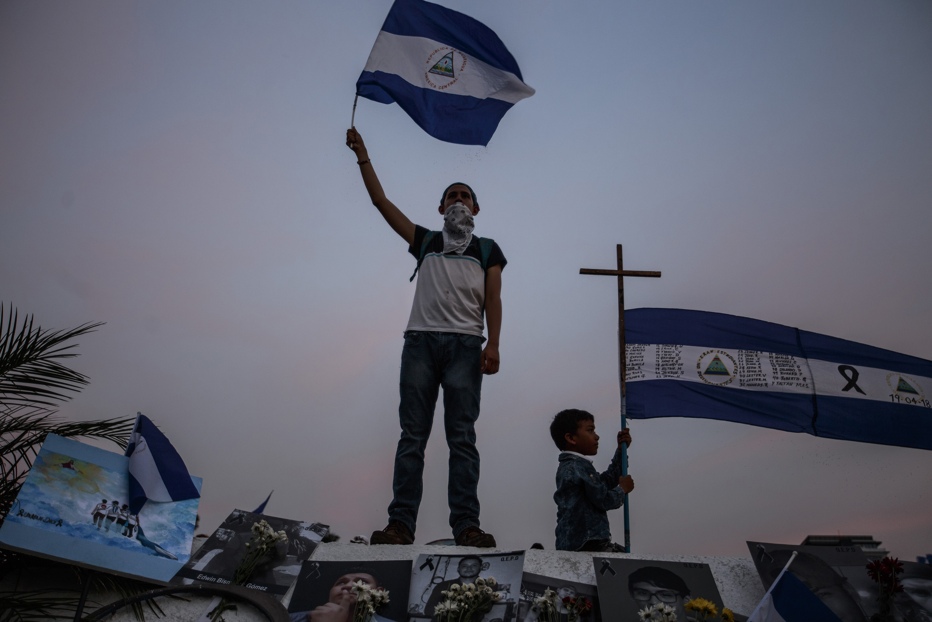 A demonstrator waves a flag during a protest in Managua on April 29. (Fred Ramos—El Faro)