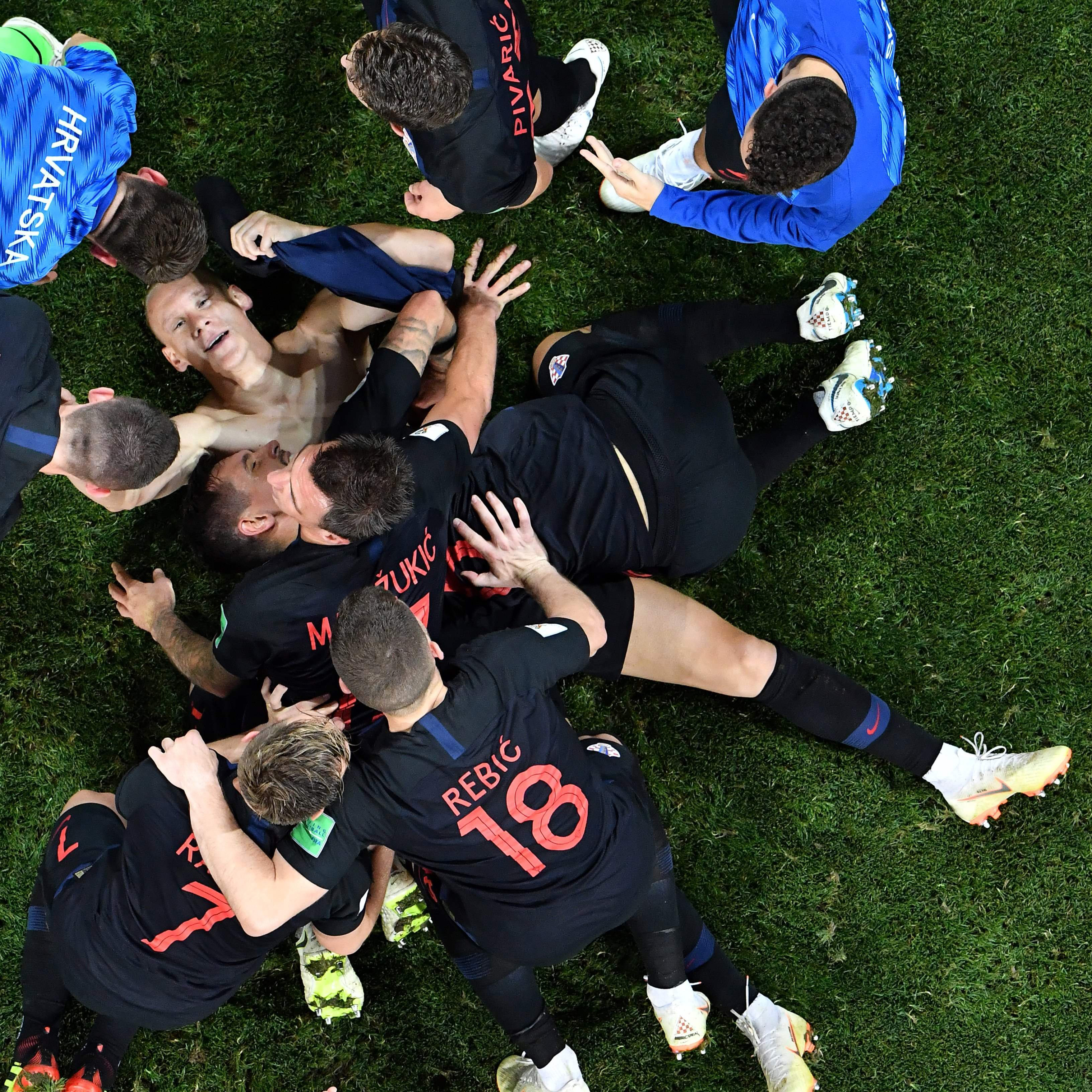 Croatia's defender Domagoj Vida (down) is congratulated by teammates after scoring a goal during the quarter final game between Russia and Croatia on July 7, 2018. (Antonin Thullier—AFP/Getty Images)