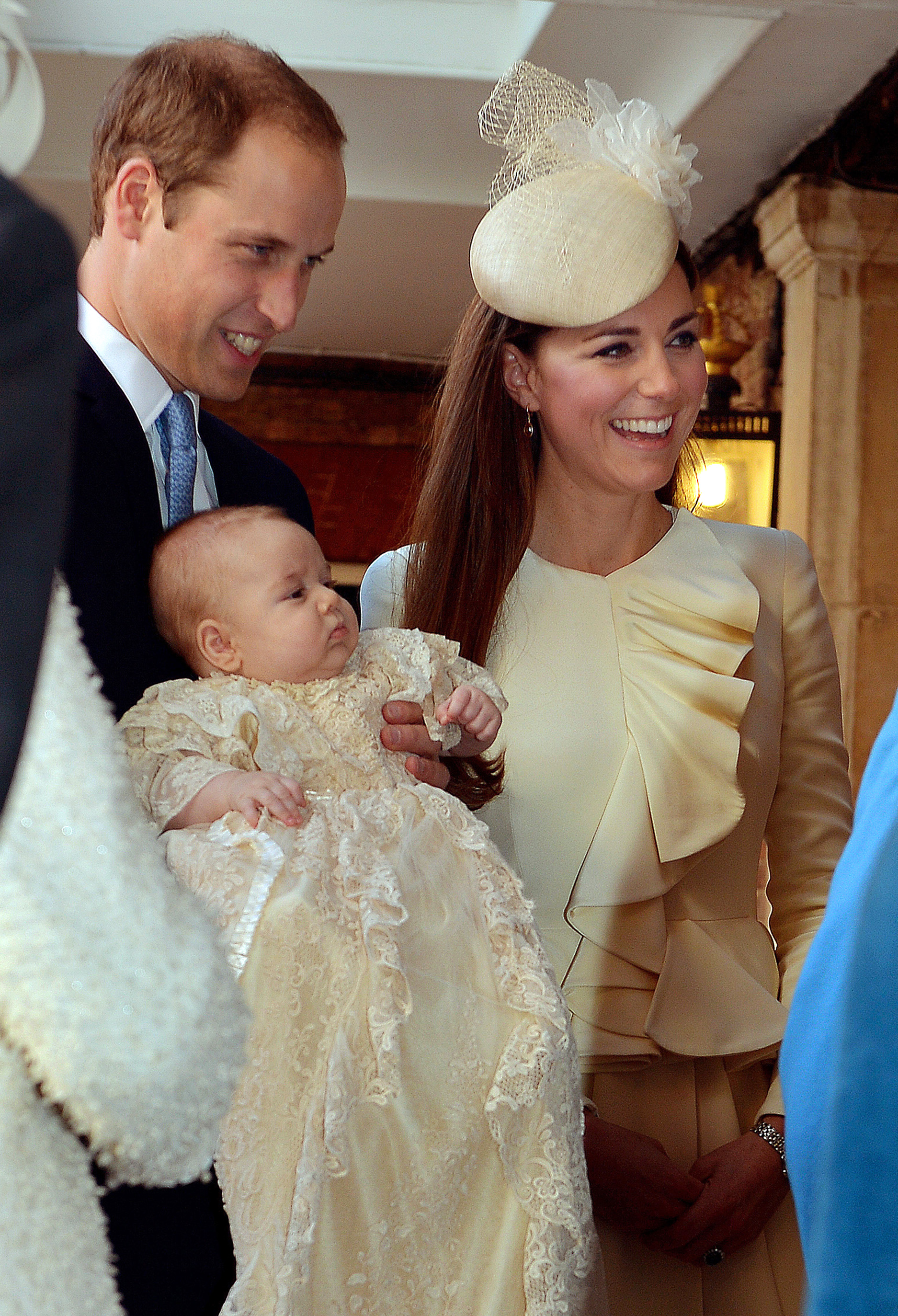 The Duke of Cambridge and his wife Catherine, Duchess of Cambridge, arrive with their son Prince George at Chapel Royal in St James's Palace in central London on October 23, 2013, ahead of the christening of the three month-old prince. (AFP—AFP/Getty Images)