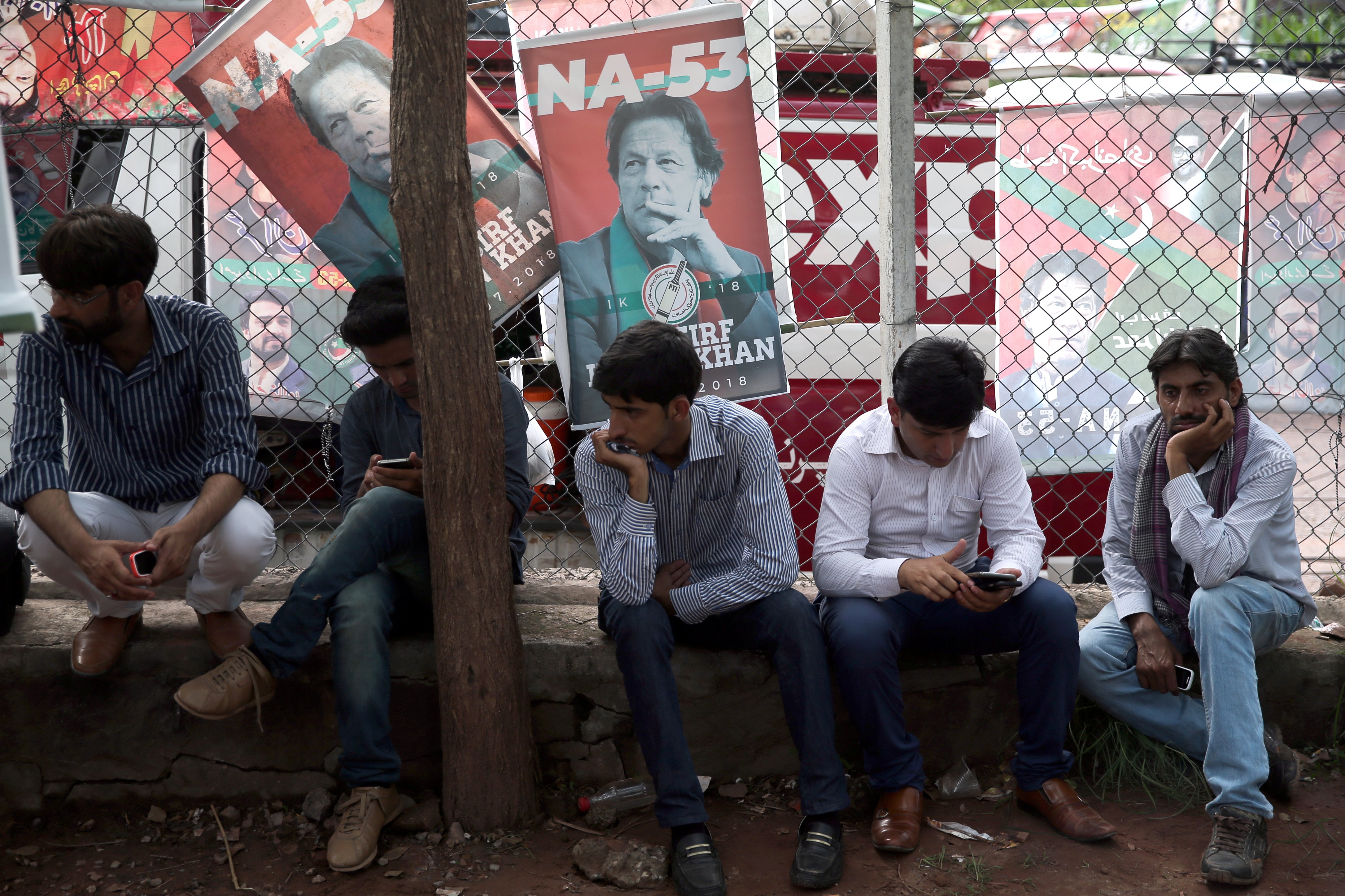 Supporters of cricket star-turned-politician Imran Khan, chairman of Pakistan Tehreek-e-Insaf (PTI), wait outside his residence, a day after the general election in Islamabad, Pakistan, July 26, 2018. (Athit Perawongmetha—Reuters)