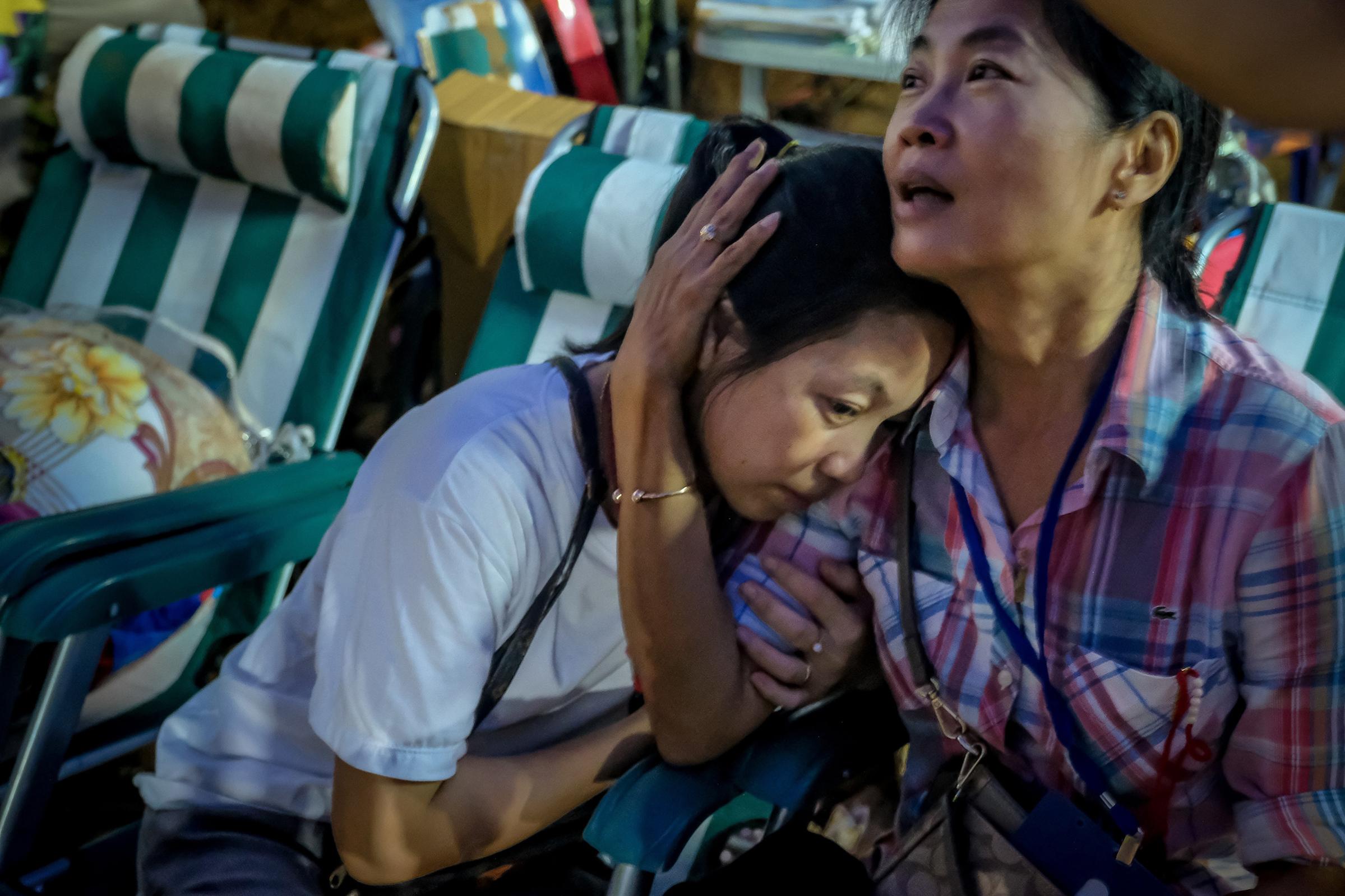 Relatives of the missing boys react after the 12 boys and their soccer coach have been found alive in the cave where they've been missing for over a week after monsoon rains blocked the main entrance on July 2, 2018 in Chiang Rai, Thailand.