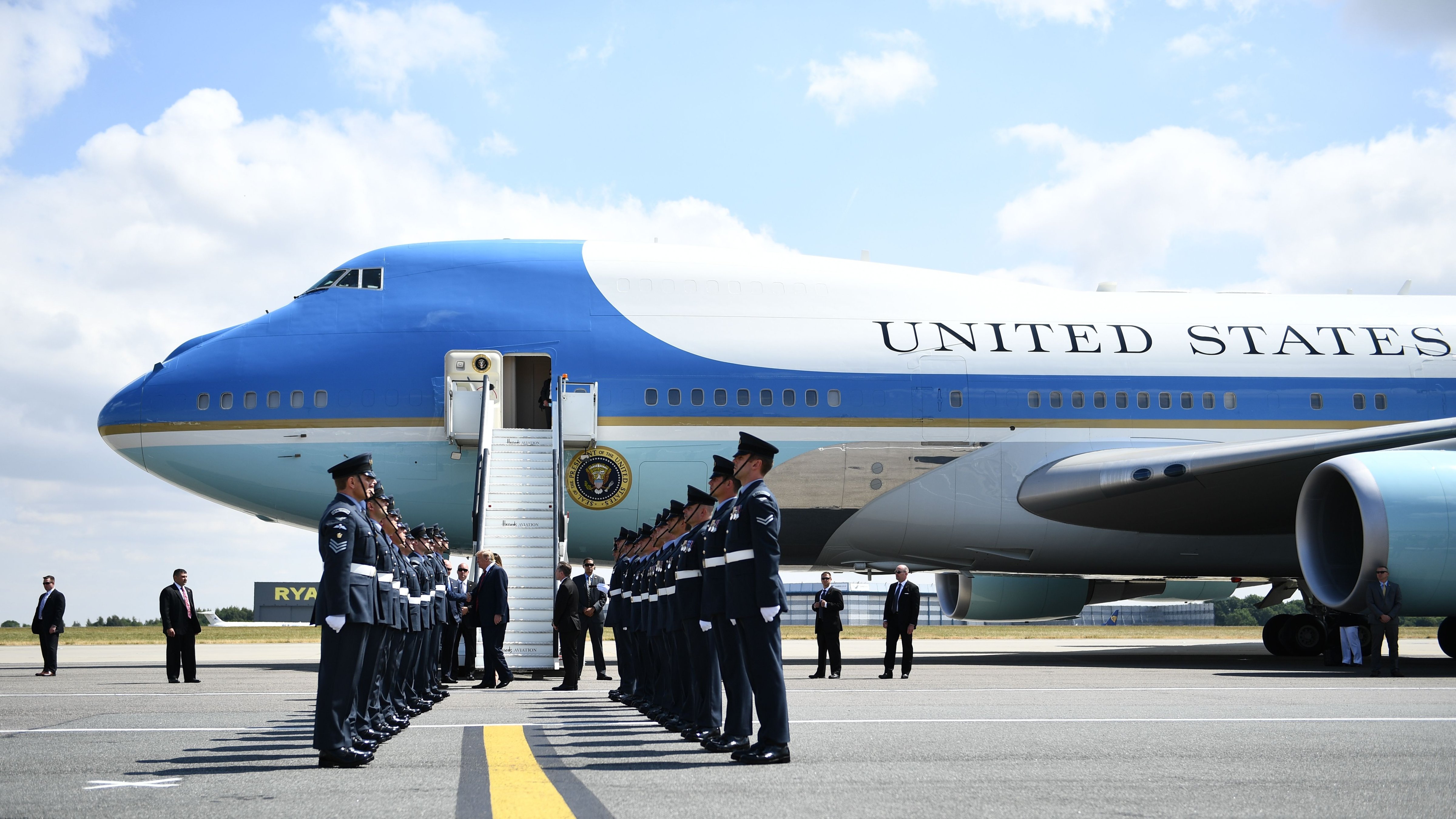 US President Donald Trump (C) and US First Lady Melania Trump are greeted by an honour guard of Royal Air Force personnel after disembarking Air Force One at Stansted Airport, north of London on July 12, 2018, as he begins his first visit to the UK as US president. (BRENDAN SMIALOWSKI&mdash;AFP/Getty Images)