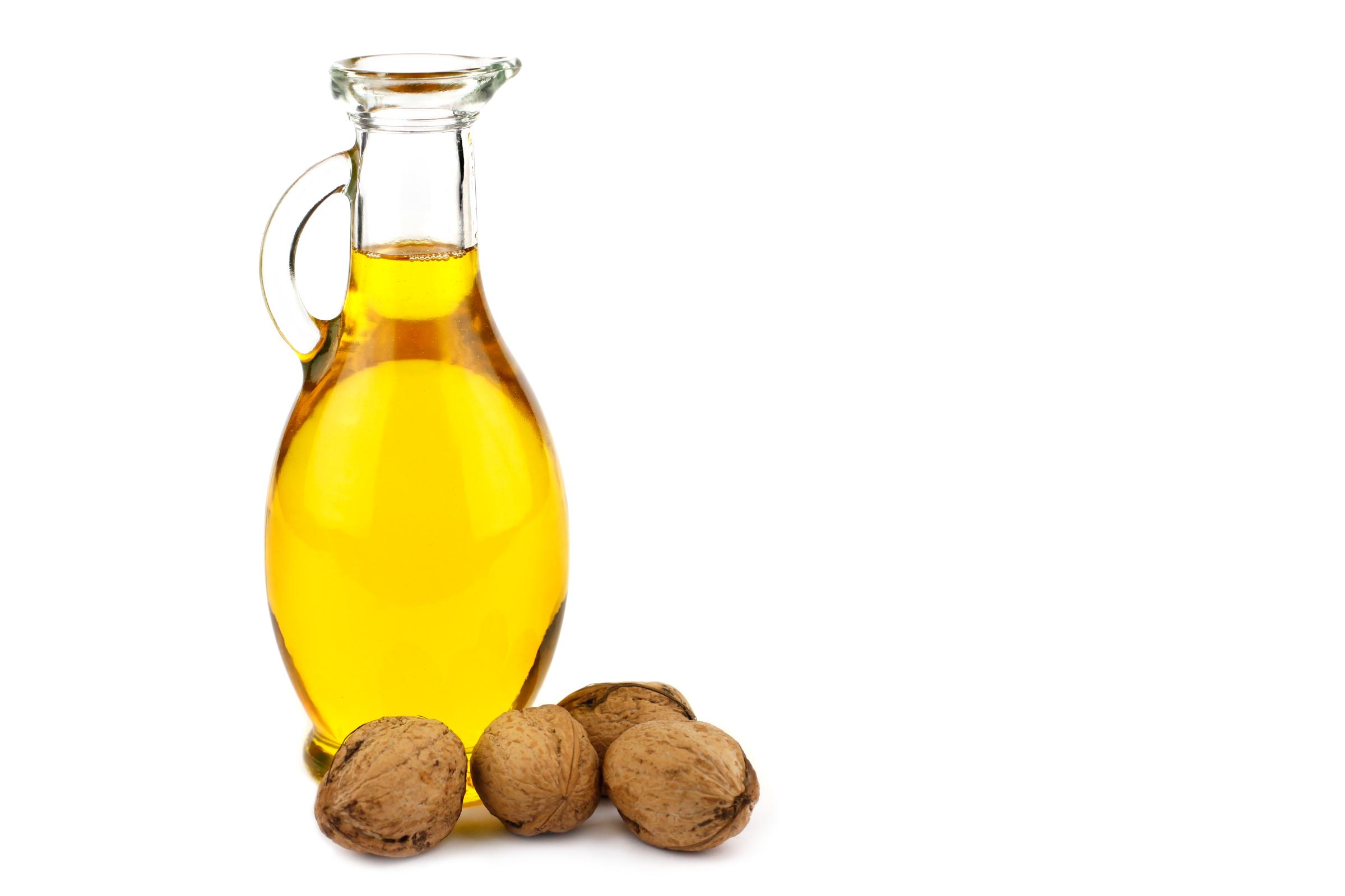 Walnut oil in bottle isolated on white background