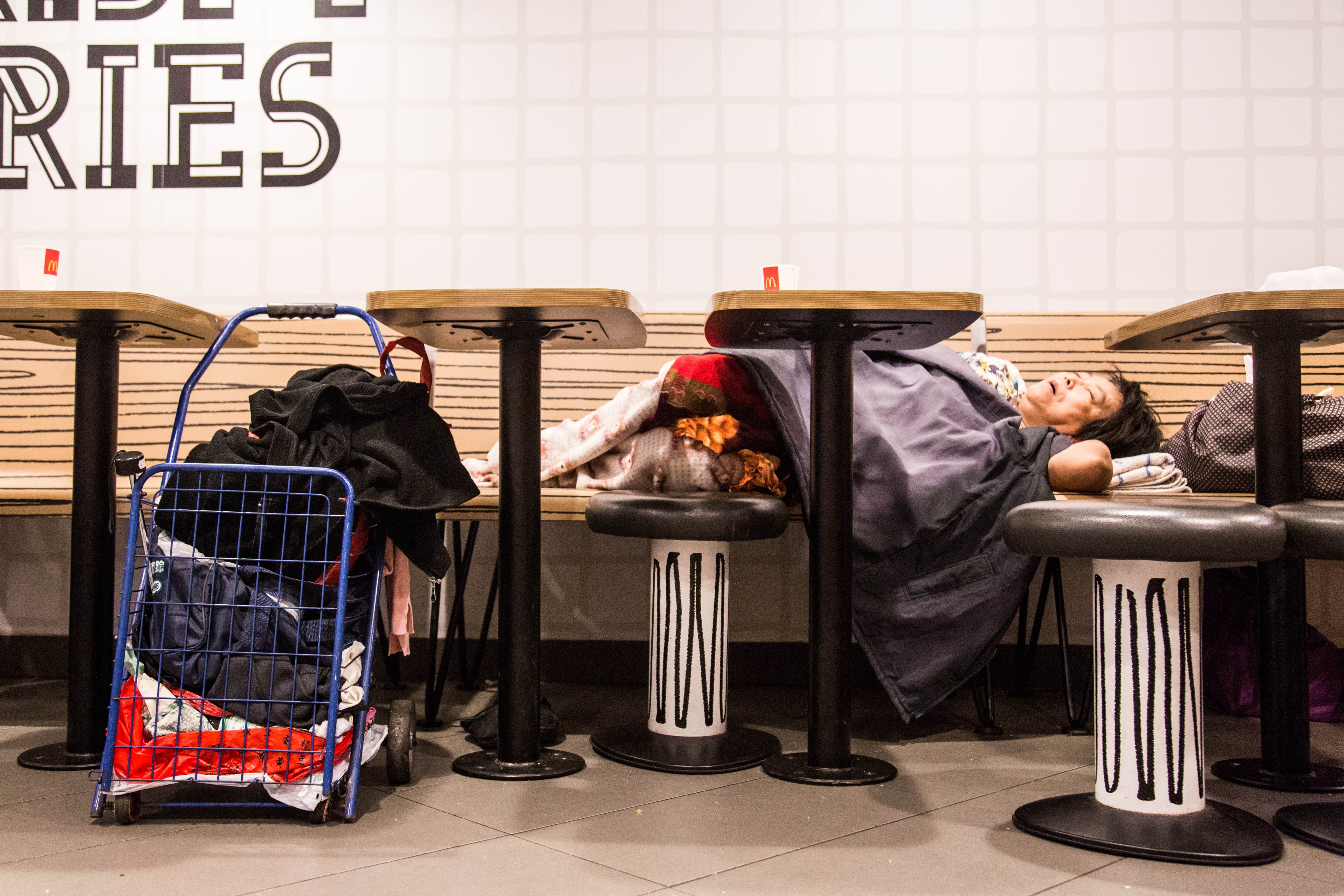 A 'McRefugee' sleeps in a restaurant in Hong Kong. (Aria Chen)