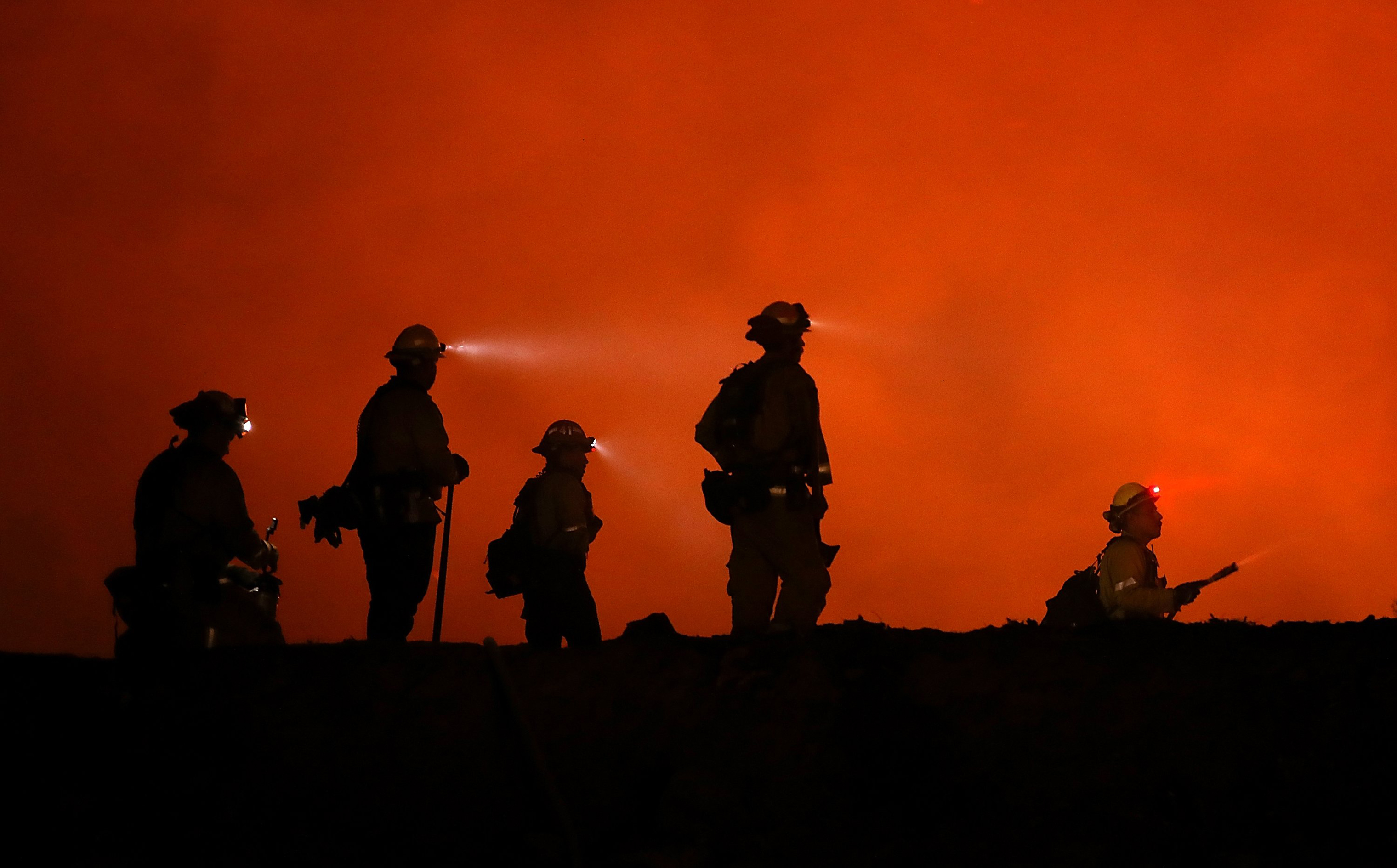 Cal Fire firefighters monitor a back fire as they battle the Medocino Complex fire near Lodoga, Calif. on Aug. 7. (Justin Sullivan—Getty Images)