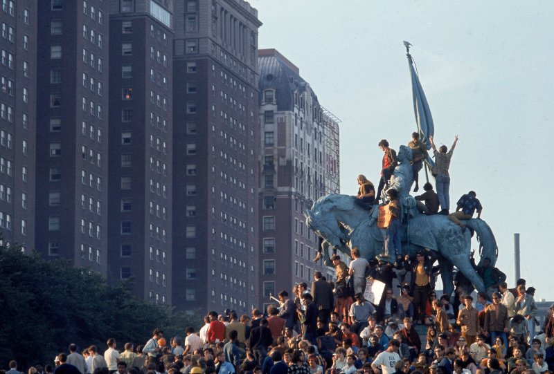 Yippie demonstrators swarming a statue in Grant Park during the 1968 Democratic National Convention.