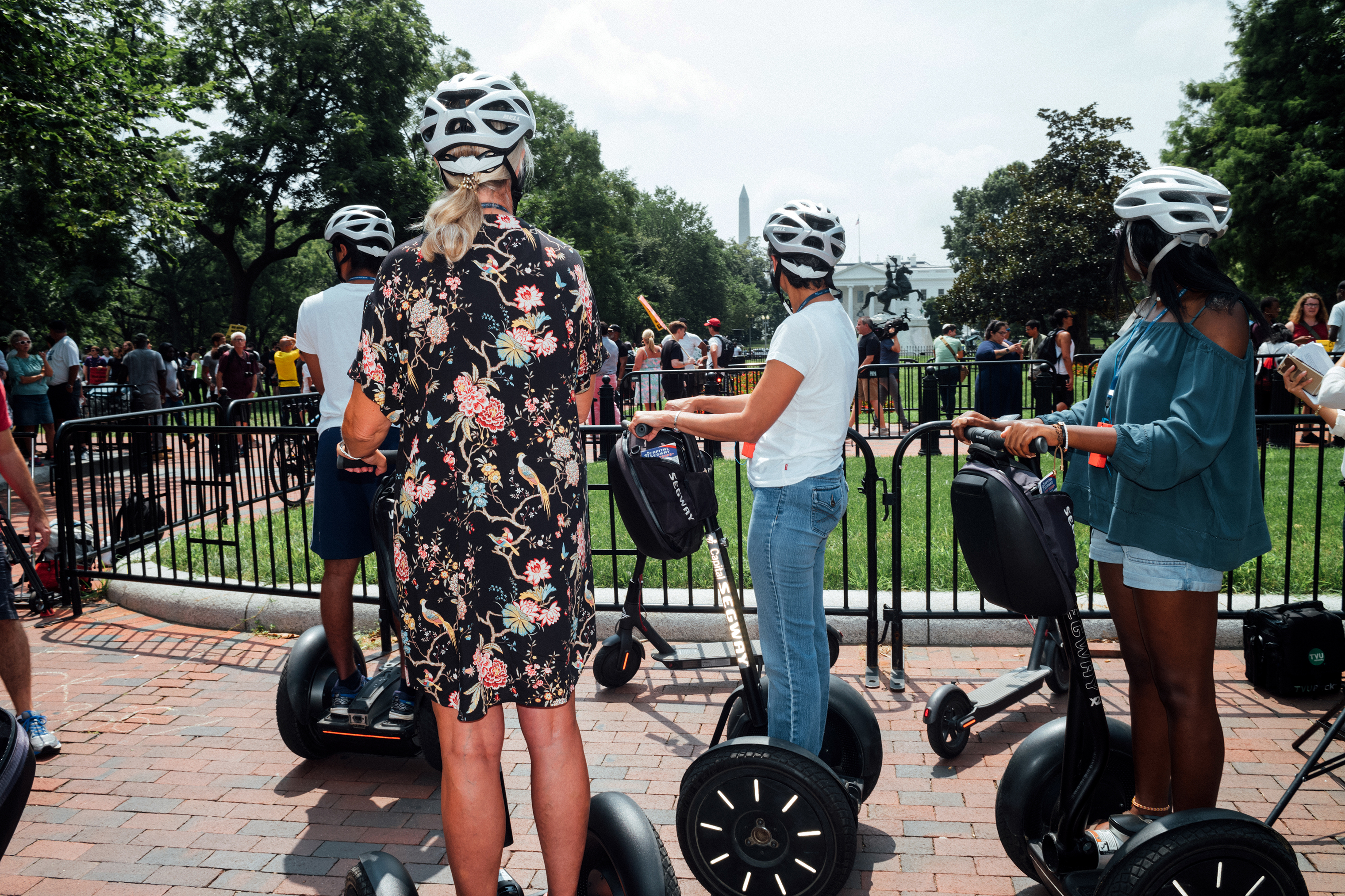 A group of passersby on scooters at Lafayette Square. (Daniel Arnold for TIME)