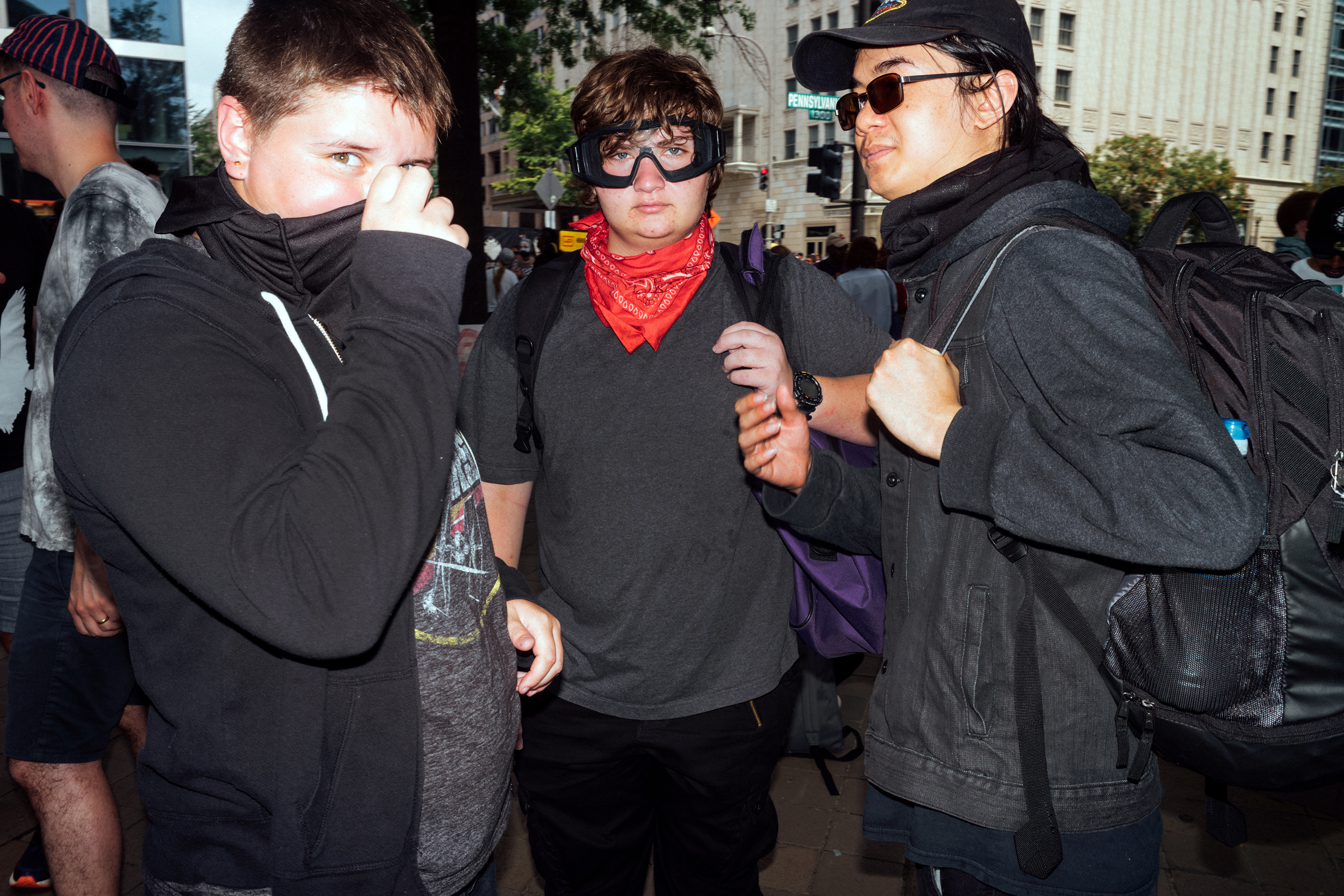 Three counter-protesters who attended the opposition demonstration at Freedom Plaza. (Daniel Arnold for TIME)