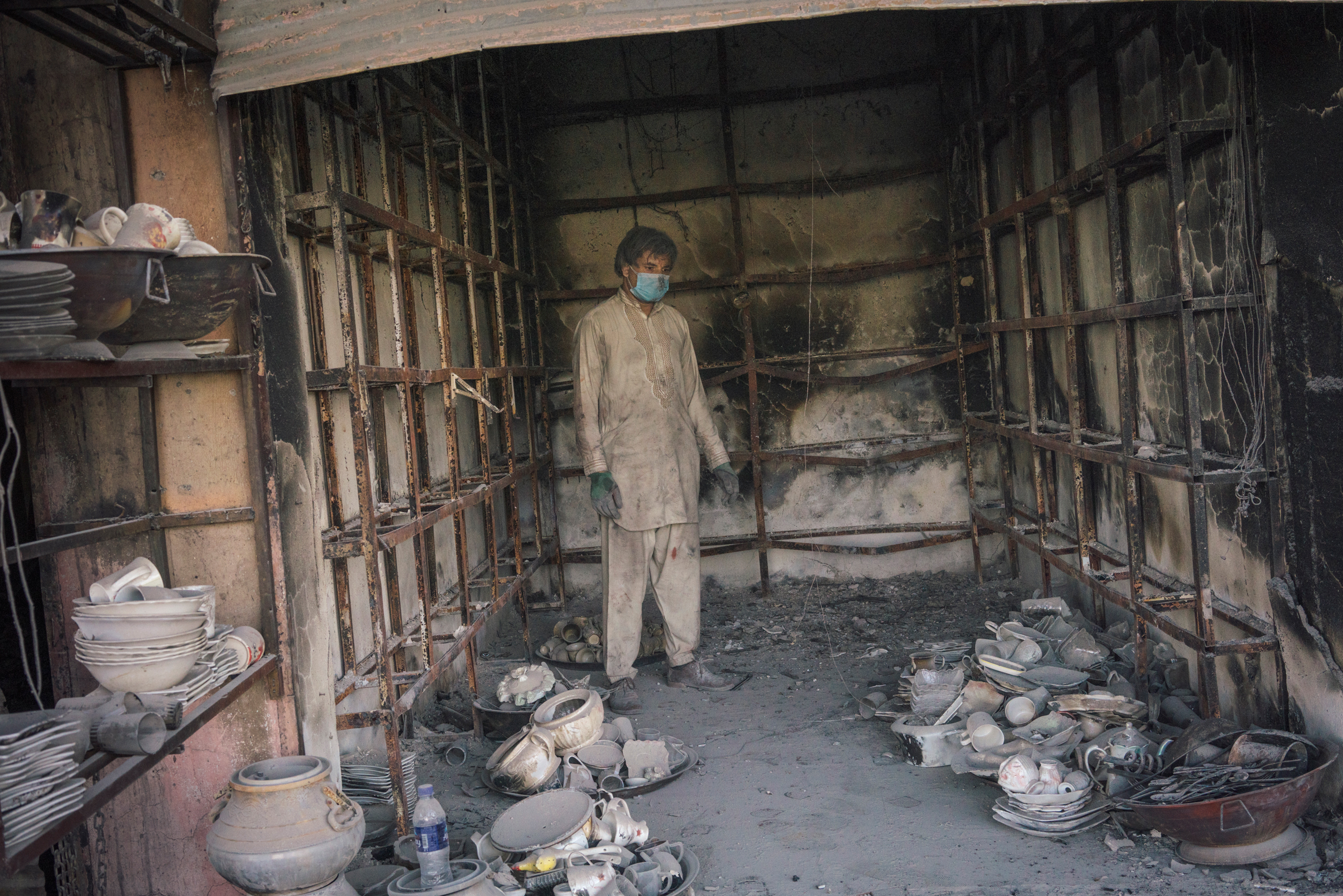 Nassarath Kadri, 27, inside his damaged shop in Ghazni on Aug. 16. (Emanuele Satolli for TIME)