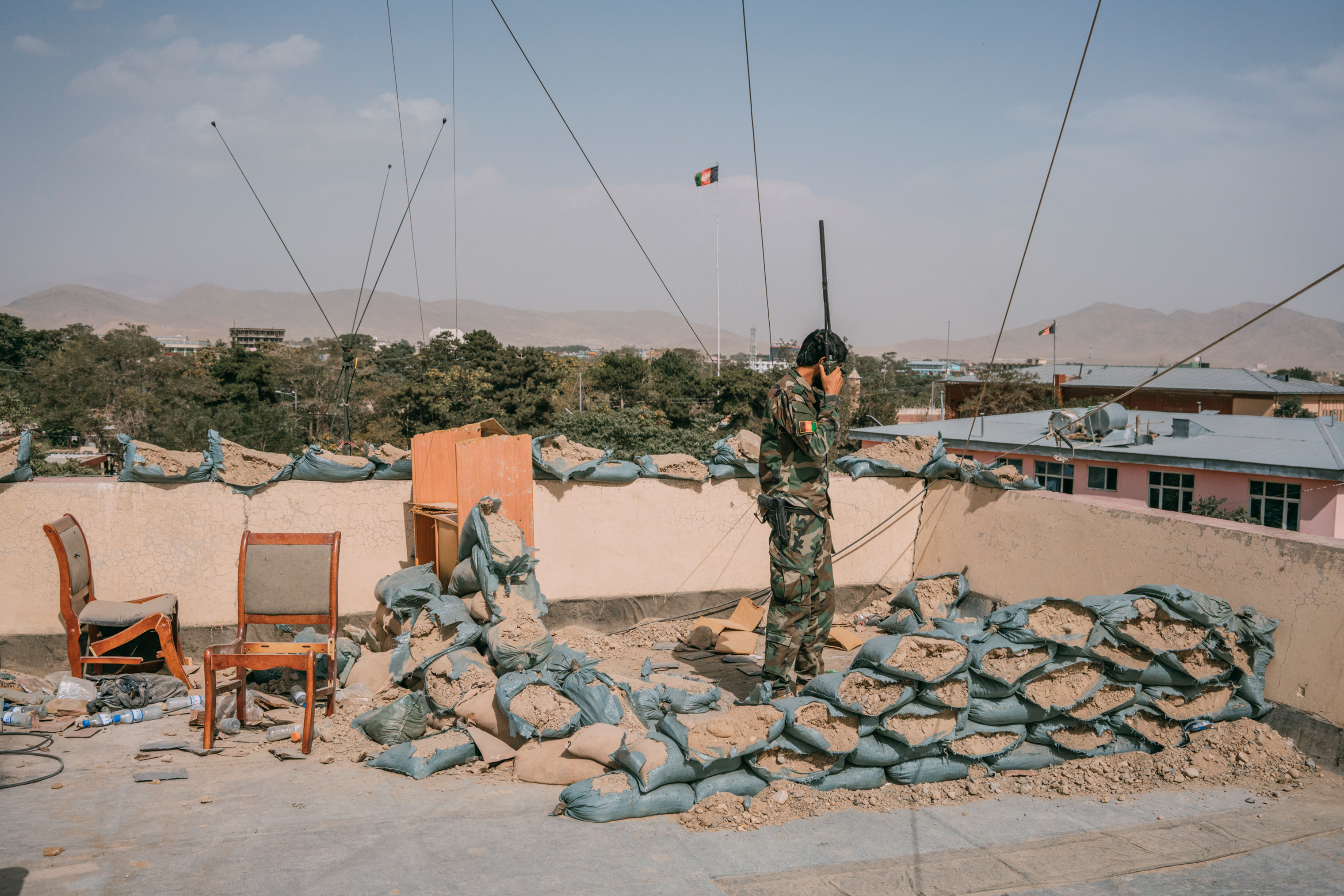 An Afghan soldier talks on a radio atop a Ghazni building. (Emanuele Satolli for TIME)