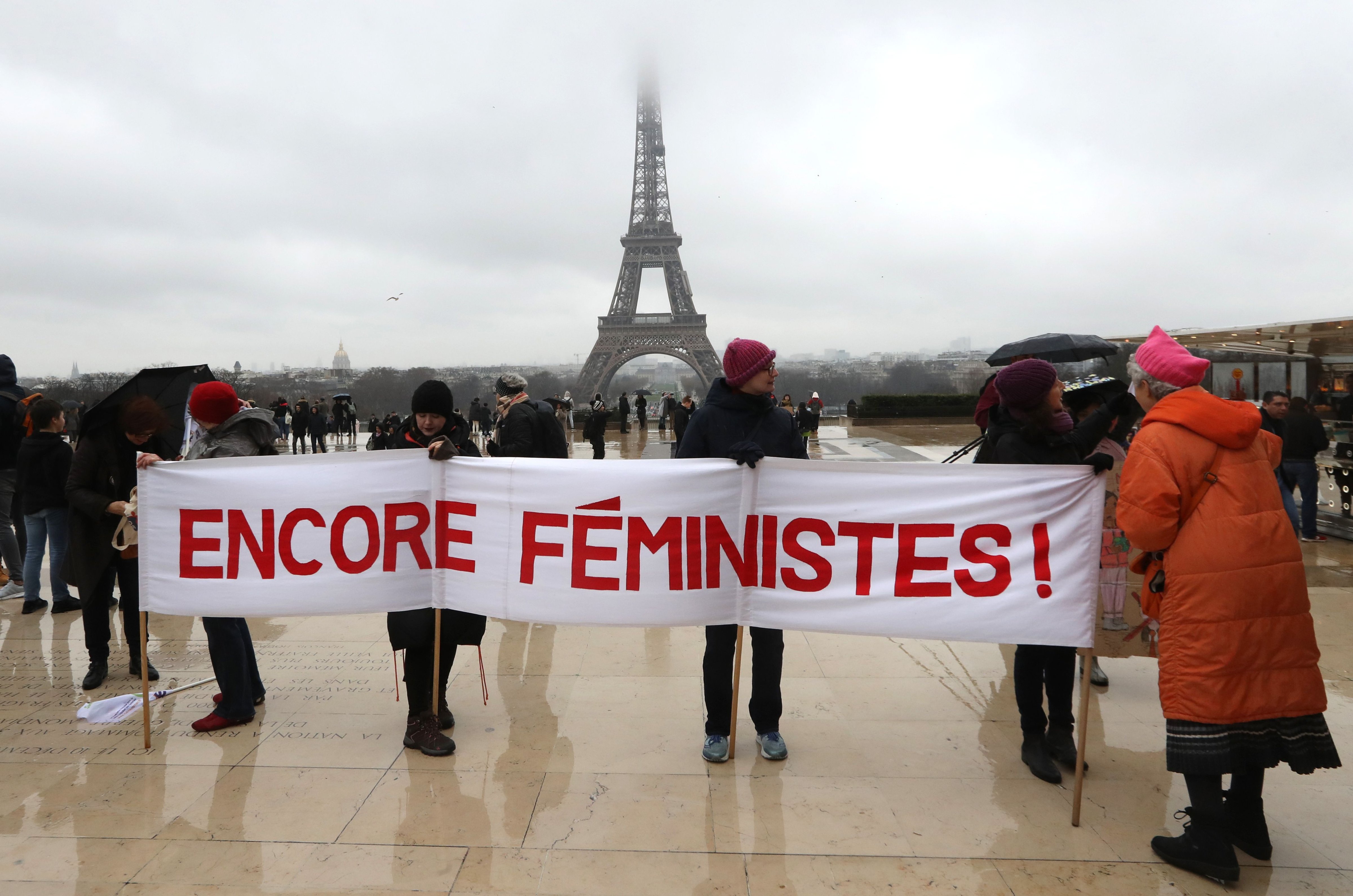 Women hold a banner reading "still feminist" with the Eiffel tower in background on the Trocadero esplanade in Paris on January 21, 2018 during a women's march organized as part of a global day of protests, a year to the day since Donald Trump took office as U.S. president. (JACQUES DEMARTHON—AFP/Getty Images)