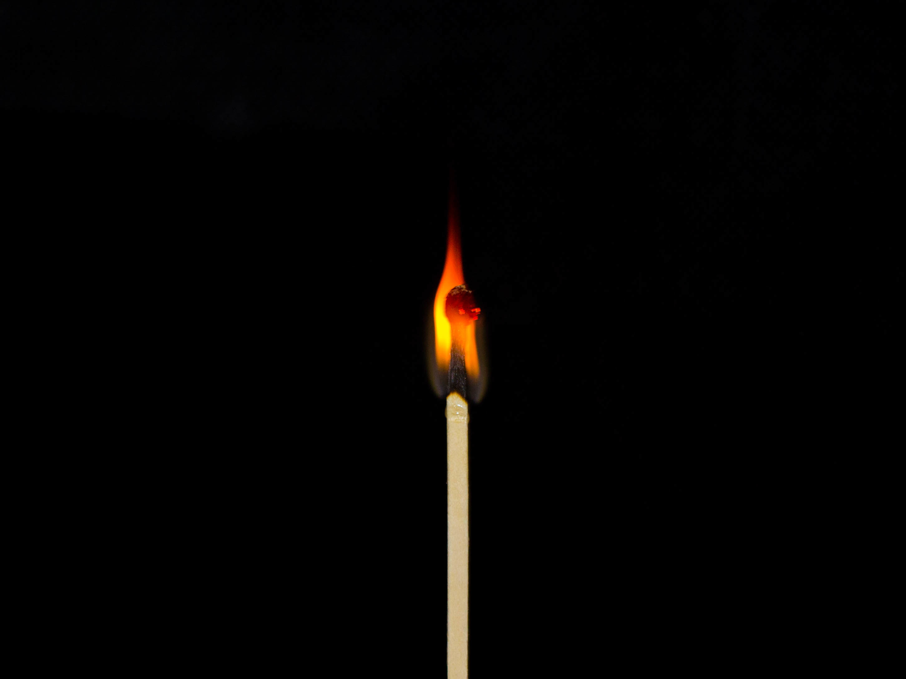 Close-Up Of Burning Matchstick Against Black Background