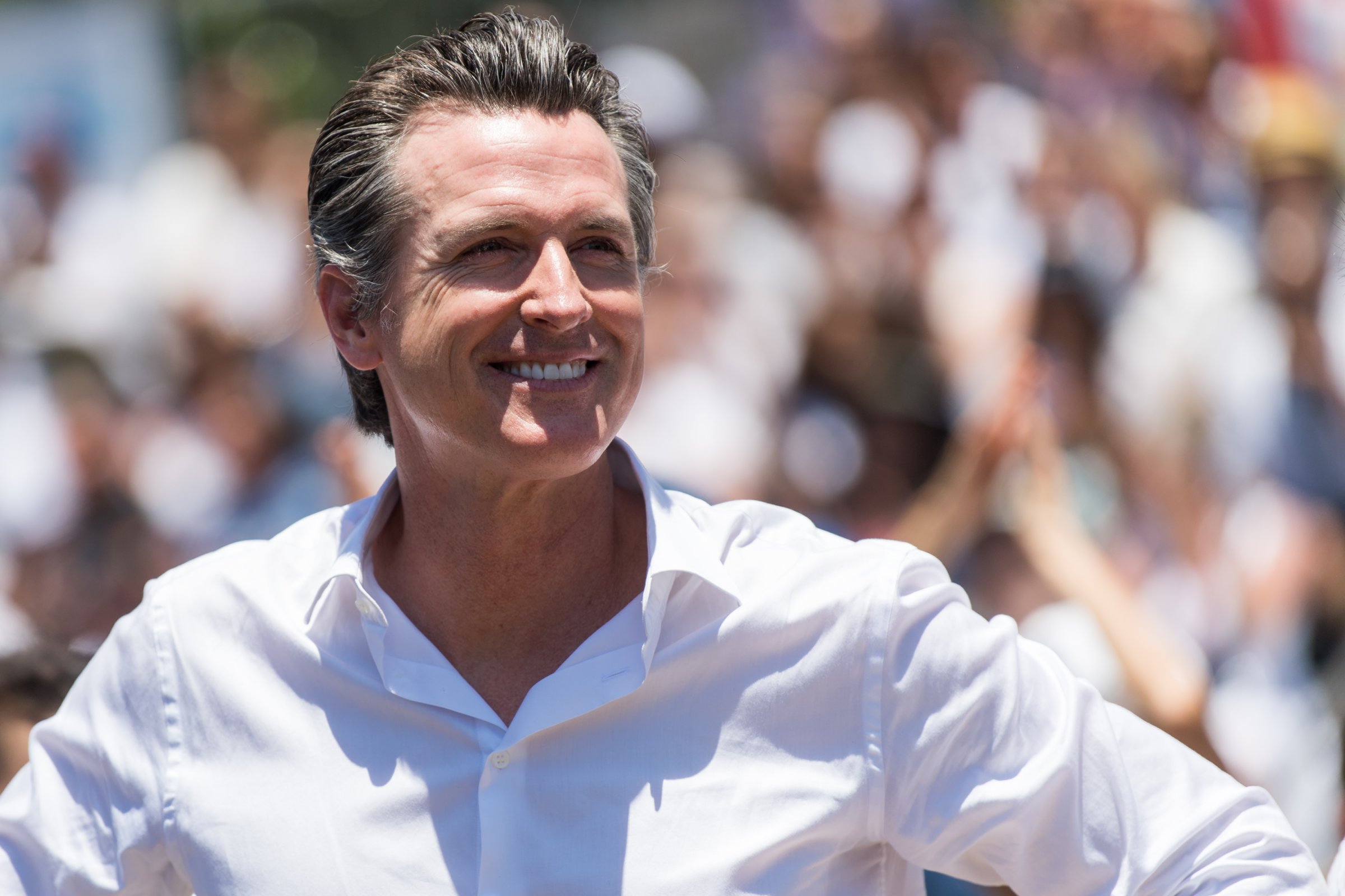 Newsom smiling to the crowd