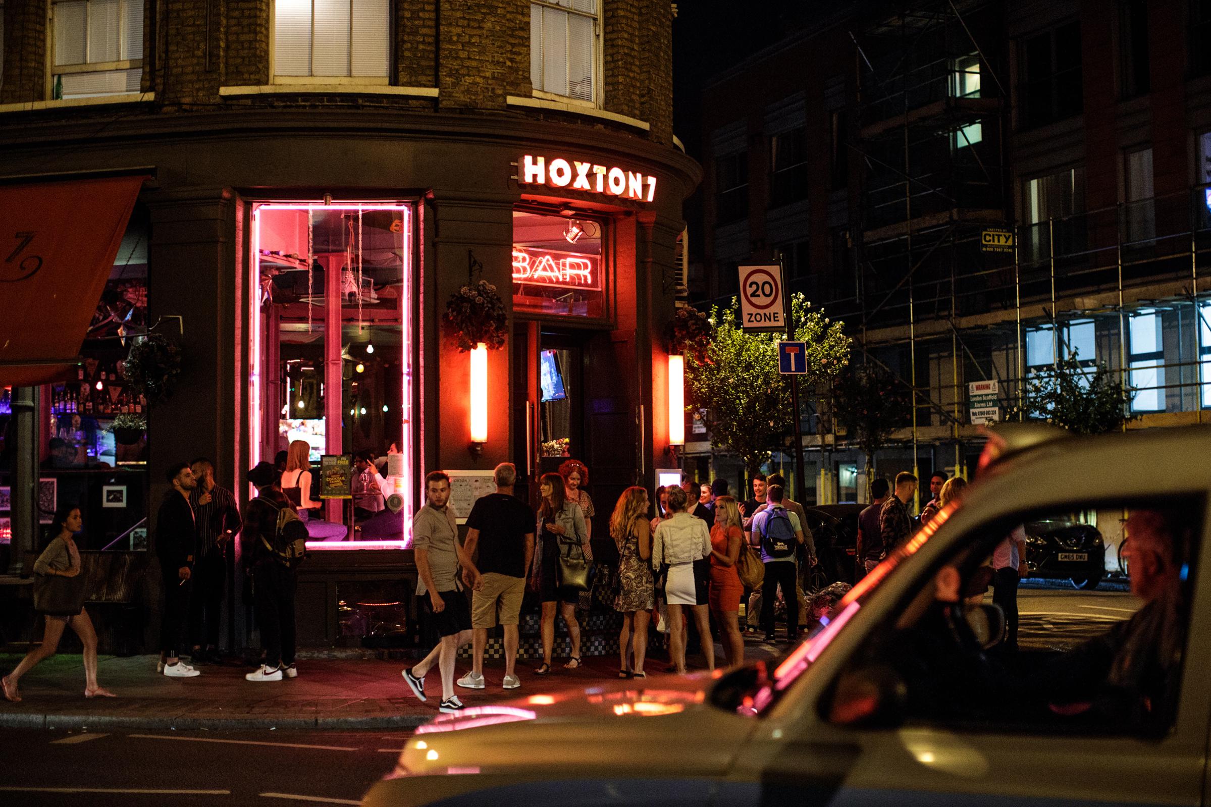 People gather outside a bar in Shoreditch, on July 28, 2018 in London, England.