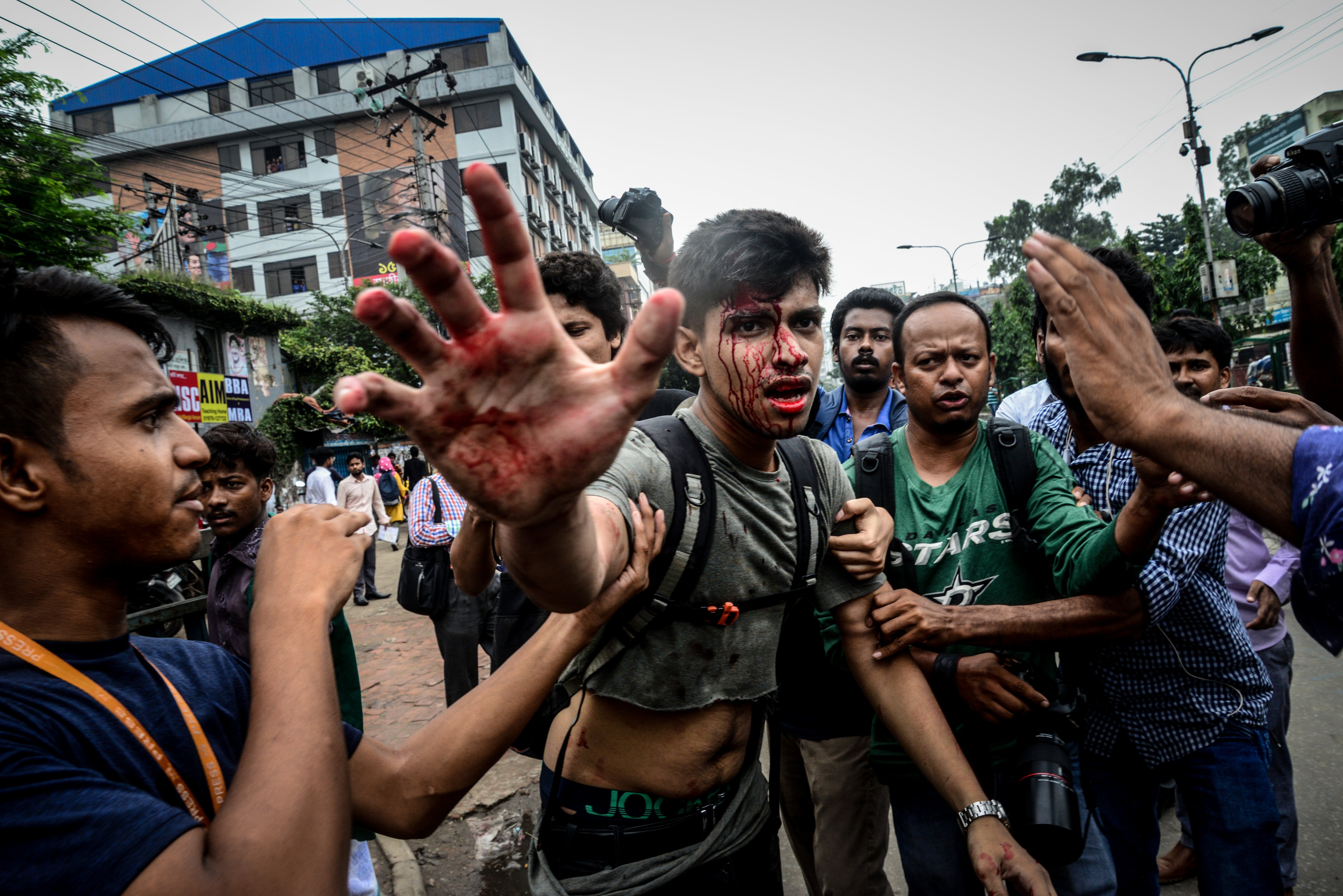 A photographer is attacked during a student protest in Dhaka on Aug. 5, 2018. (Mamunur Rashid—NurPhoto/Getty Images)