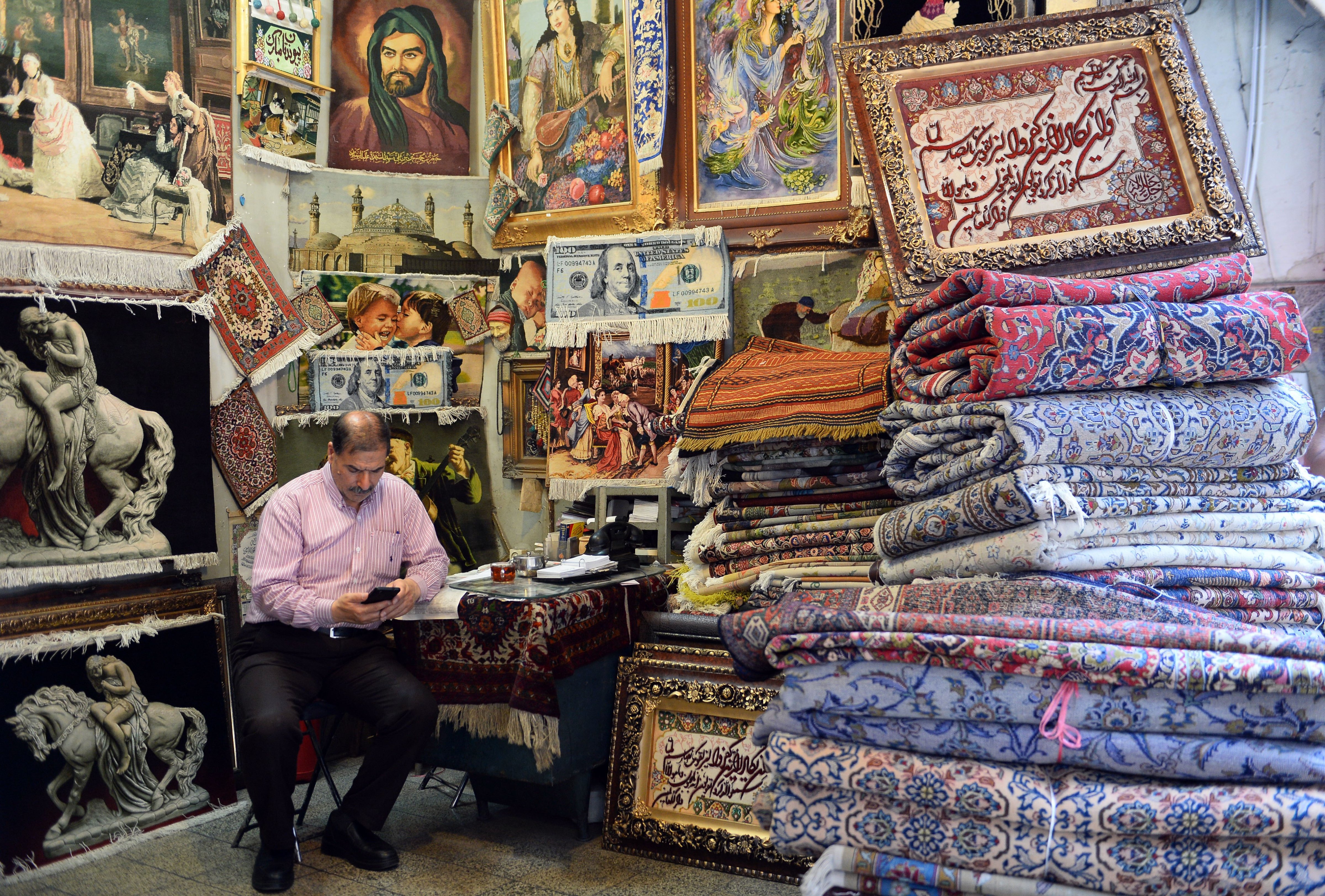 A carpet seller is seen at a bazaar in Tehran a day before the U.S. re-enforced sanctions against Iran on Aug. 7, 2018 (Anadolu Agency—Getty Images)