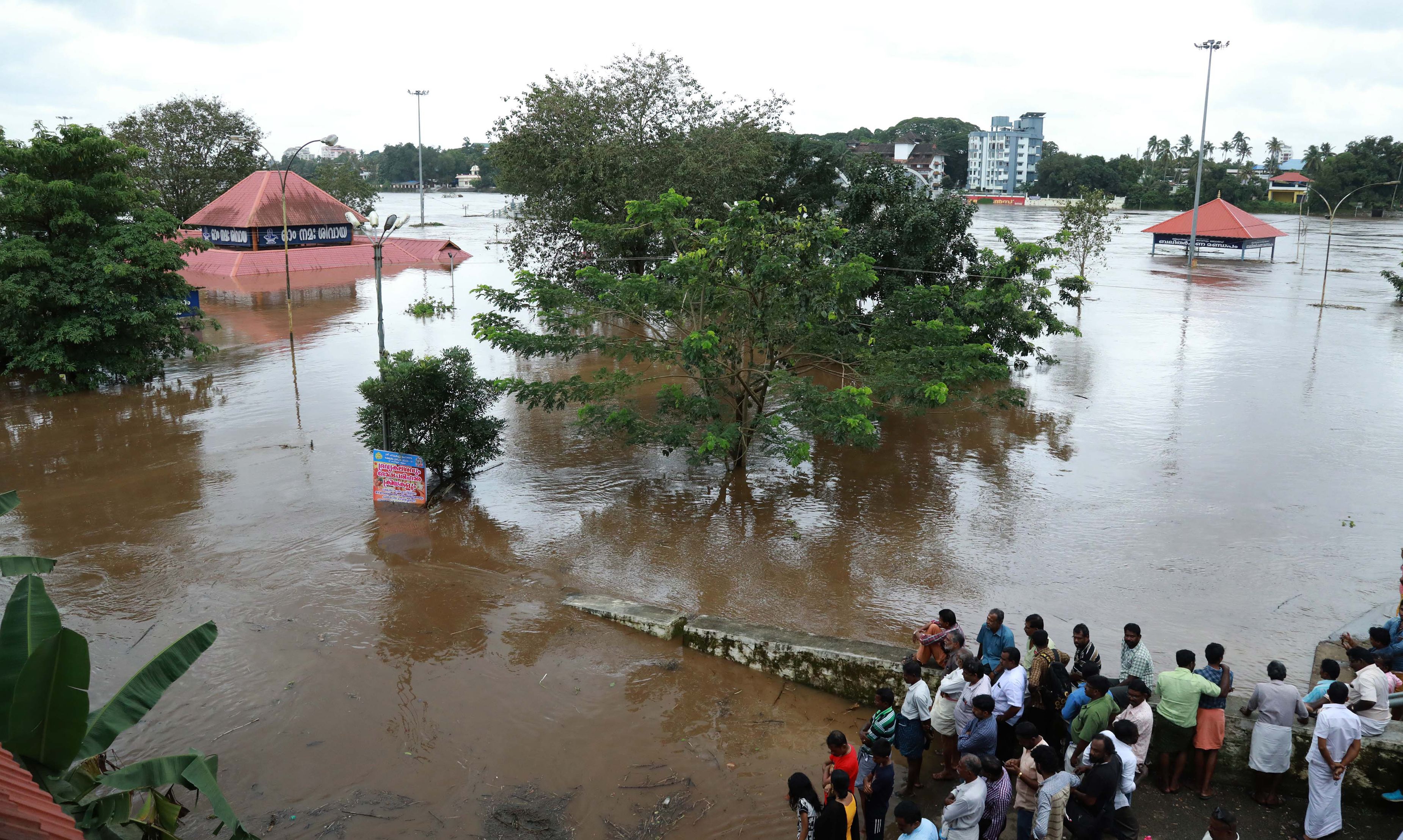 Indian residents look at the Shiva Temple submerged after the release of water from Idamalayar dam following heavy rains in Kochi on Aug. 9, 2018. (AFP/Getty Images)