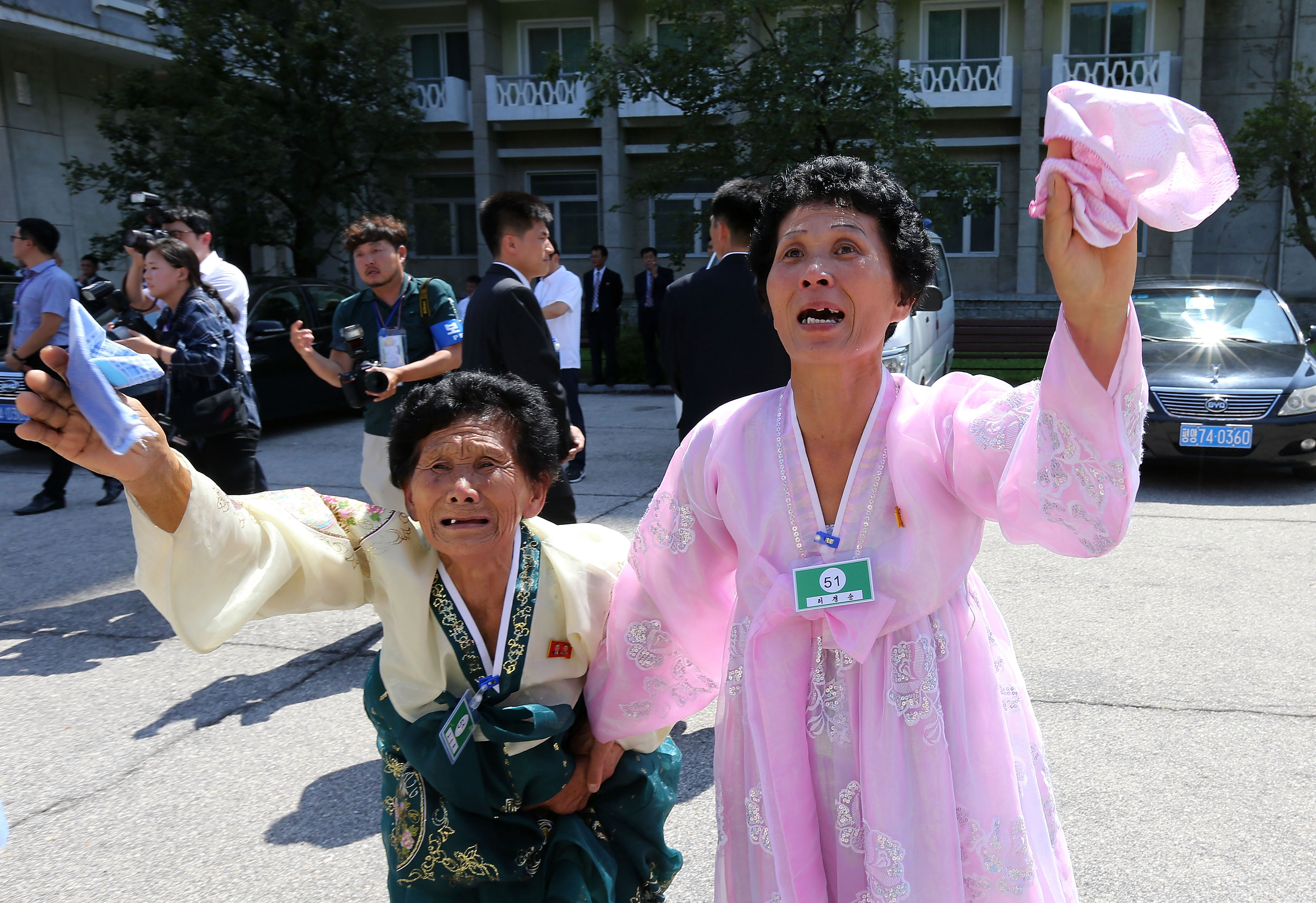 North Koreans wave to their South Korean family returning home after a separated family reunion meeting at in Mount Kumgang, North Korea on Aug. 22, 2018. (O Jong-Chan—Korea Pool/Getty Images)