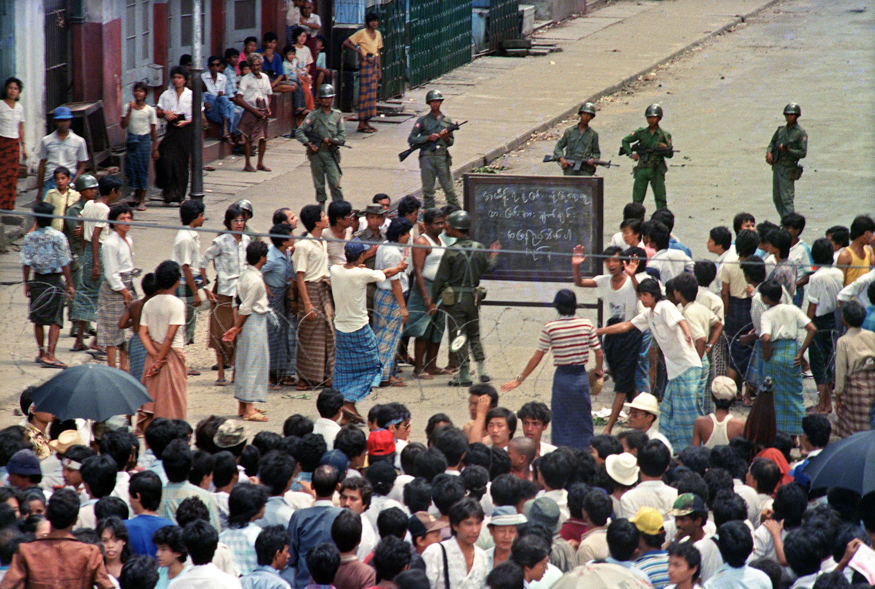 Troops order a crowd 26 Aug. 1988 in downtown Rangoon (Yangon) to disperse in front of sule pagoda sealed off by barbed wires. (Tommaso Villani—AFP/Getty Images)