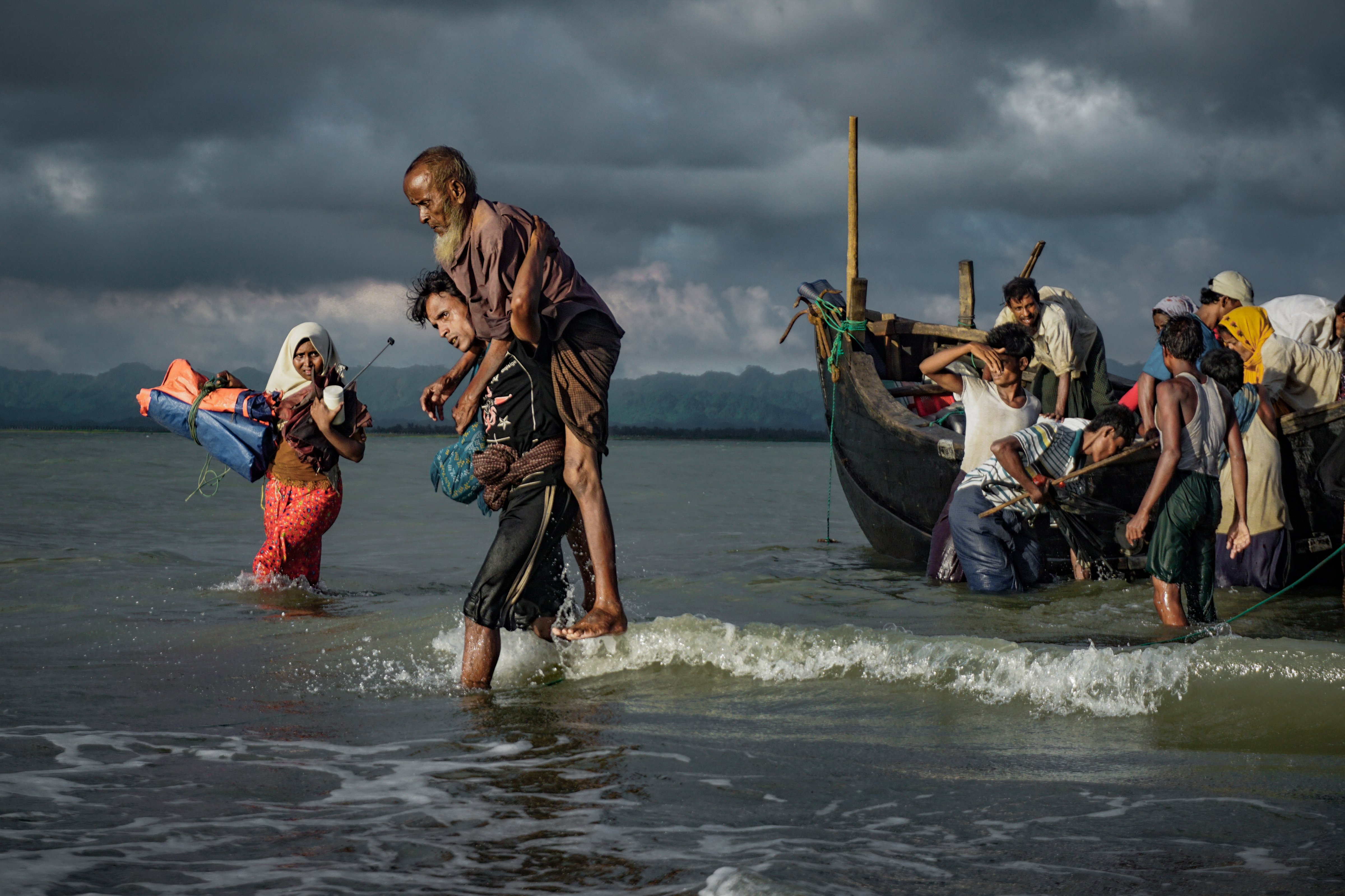 Rohingya Muslim refugees disembark from a boat on the Bangladeshi side of Naf river in Teknaf on Sept. 13, 2017. (NurPhoto/Getty Images)