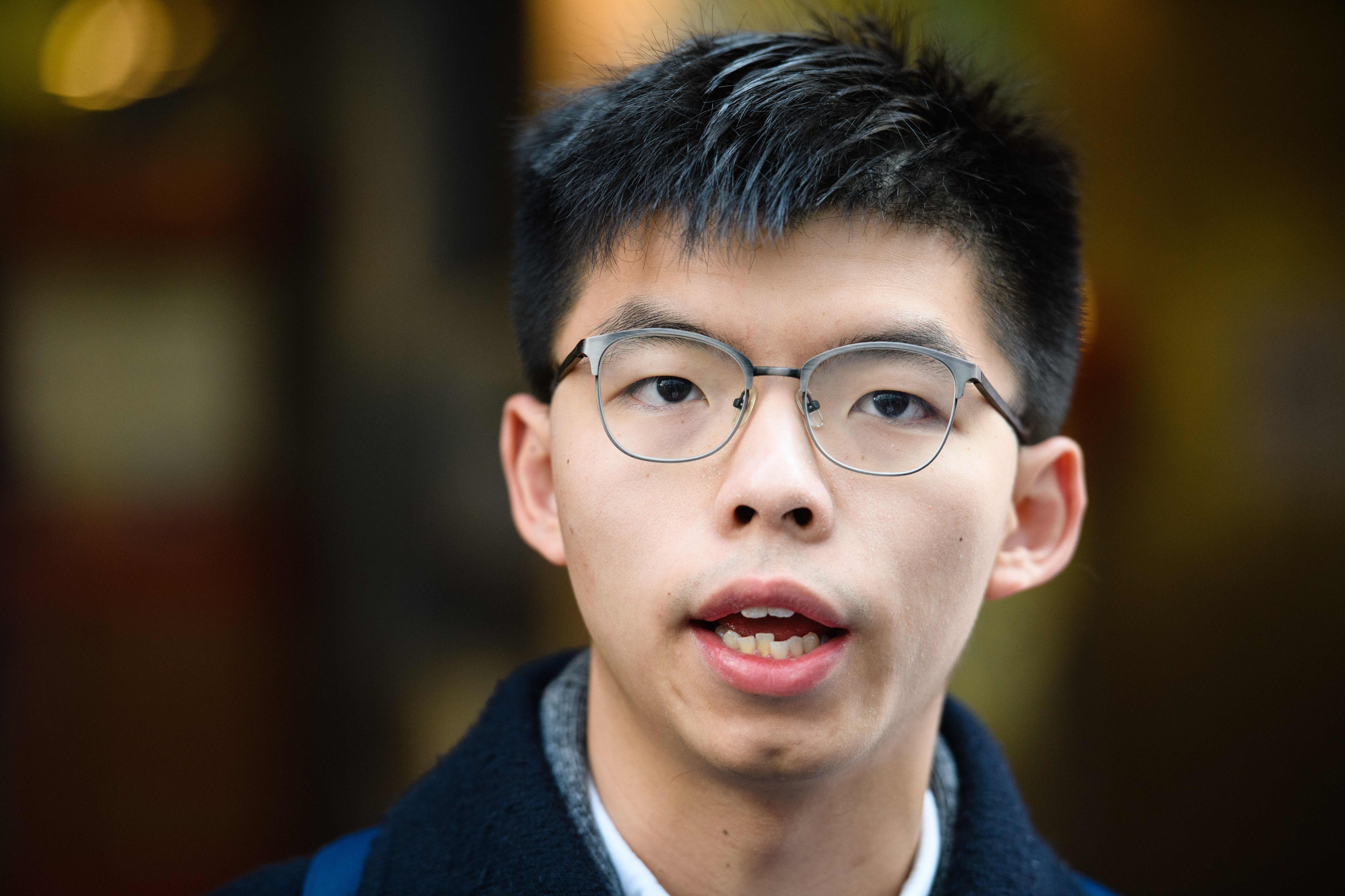 Pro-democracy campaigner Joshua Wong speaks tot he press outside a polling station in Hong Kong on March 11, 2018. (Anthony Wallace—AFP/Getty Images)
