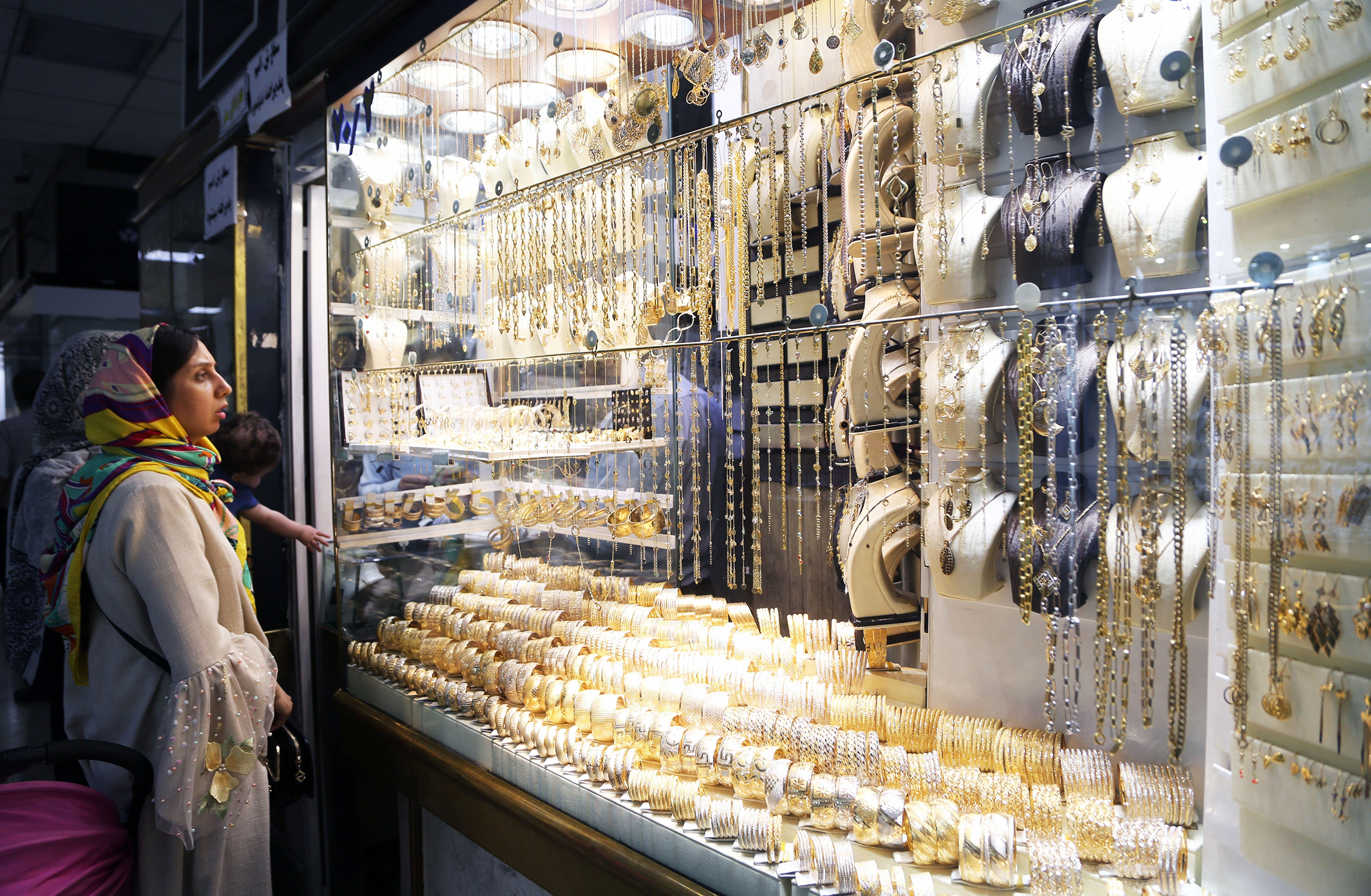 A woman looks at golden jewelleries at Grand Bazaar as daily life continues despite of the U.S. sanctions against Iran on August 08, 2018 in Tehran, Iran. (Fatemeh Bahrami—Anadolu Agency/Getty Images)