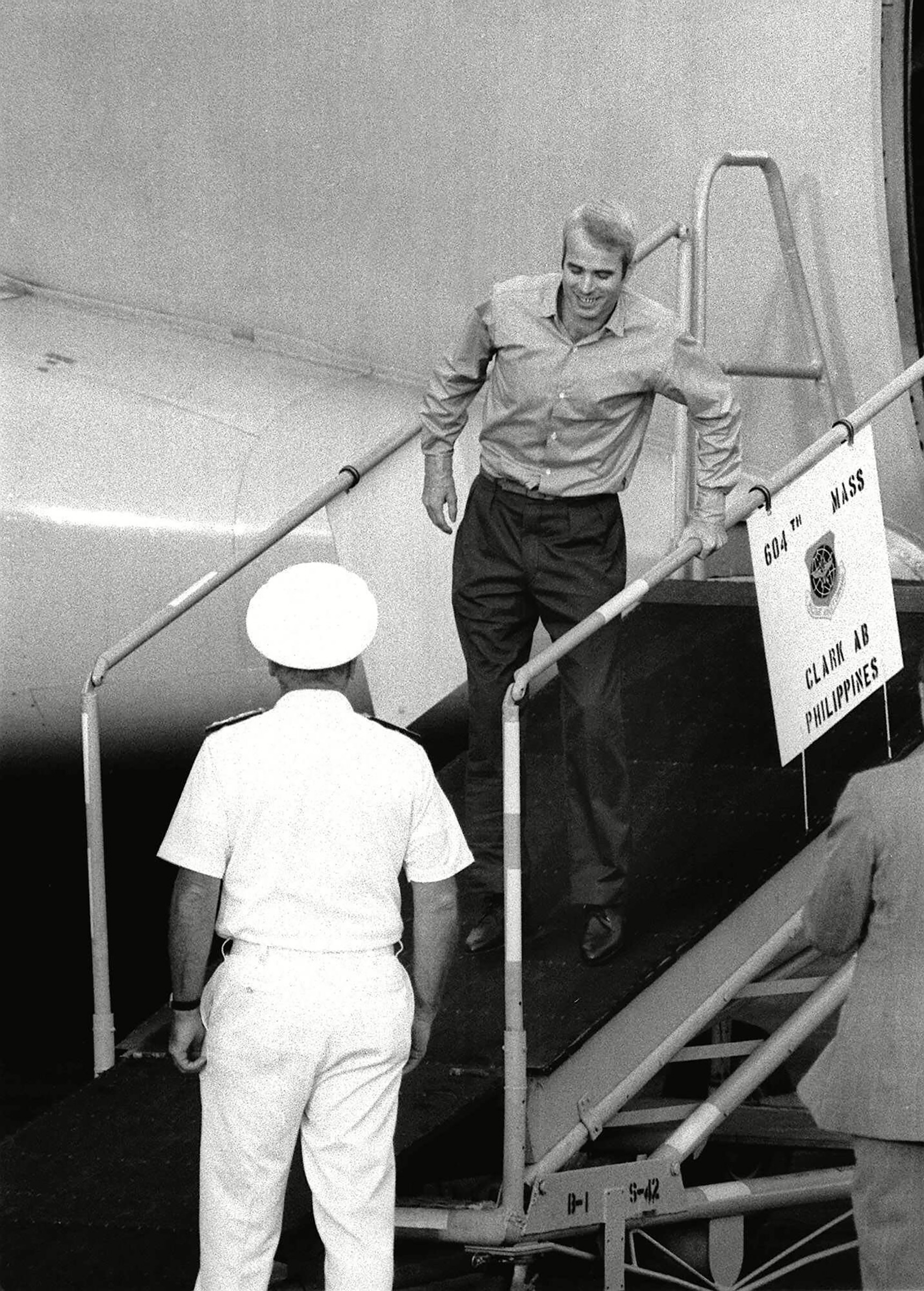 Lt. Cdr. John McCain limps down ramp for a welcome as he arrives at Clark Air Base in The Philippines, from captivity in Hanoi. (AP/REX/Shutterstock)