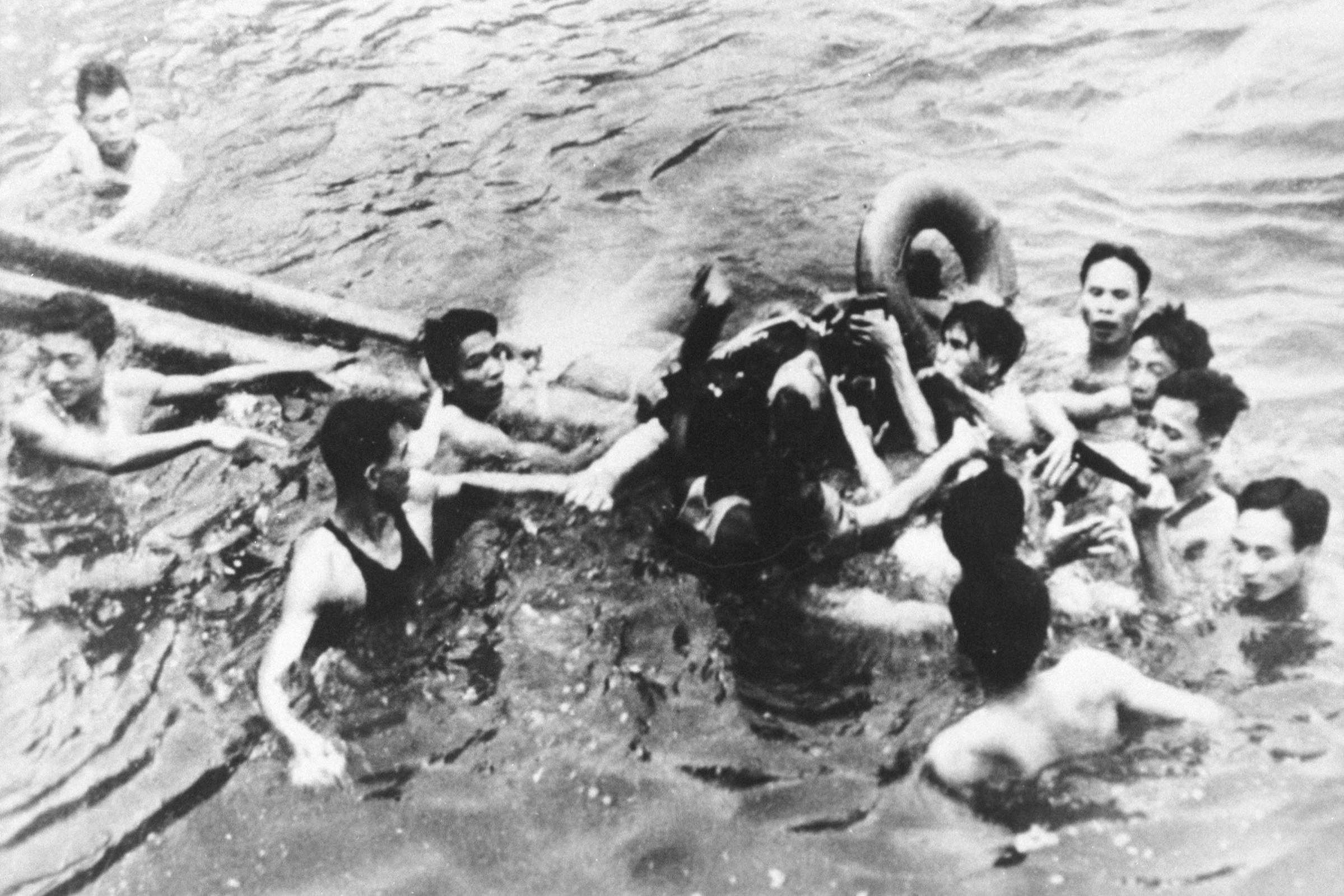 Senator John McCain is pulled out of a Hanoi lake by North Vietnamese army soldiers and civilians on Oct. 26, 1967.