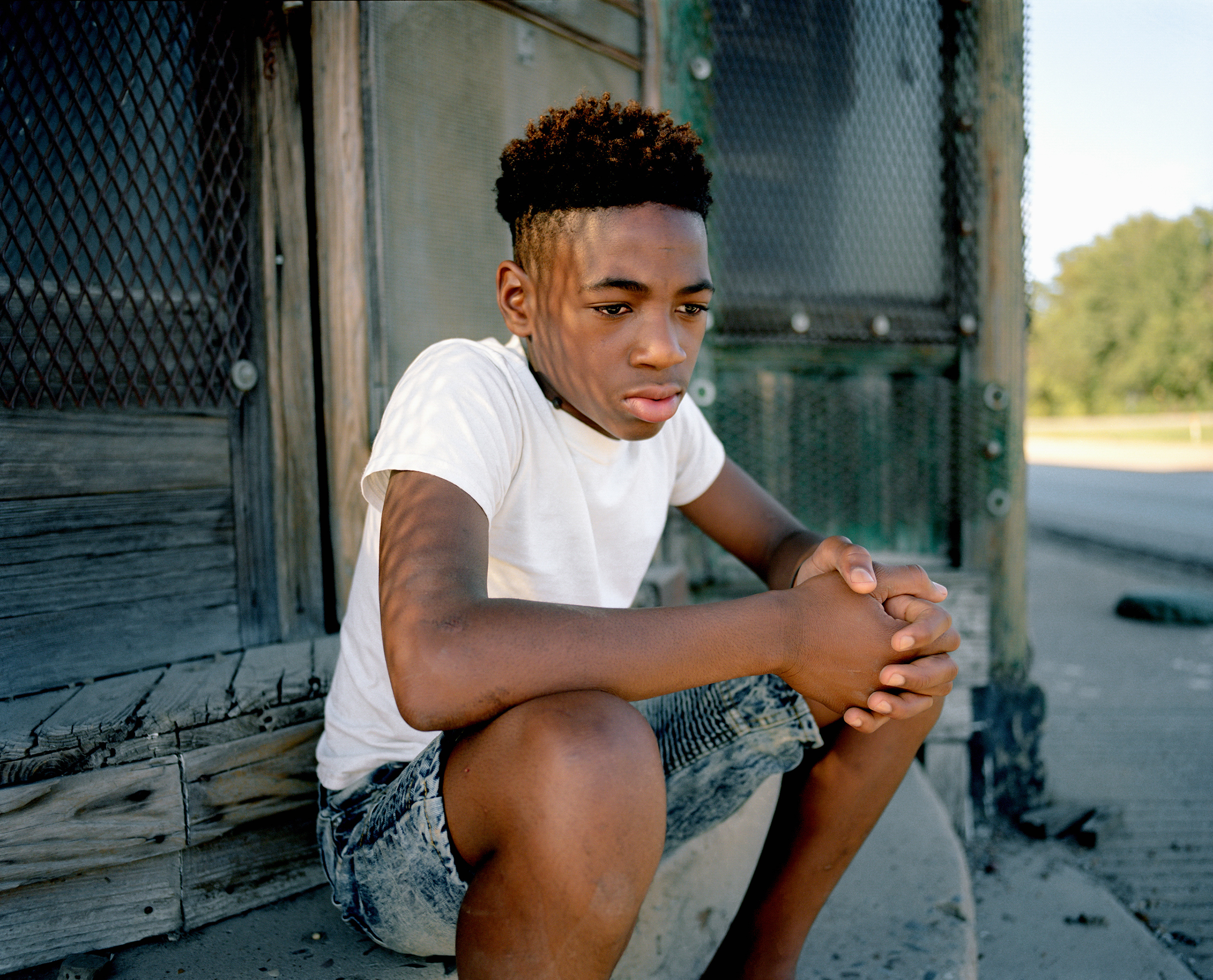 Dequincy Wilson sits on the steps of an old general store located in downtown Elaine, Ark. The community rarely brings up the 1919 Race Massacre, and the younger generation has little to no remembrance of the town’s convoluted history. (Johnathon Kelso)