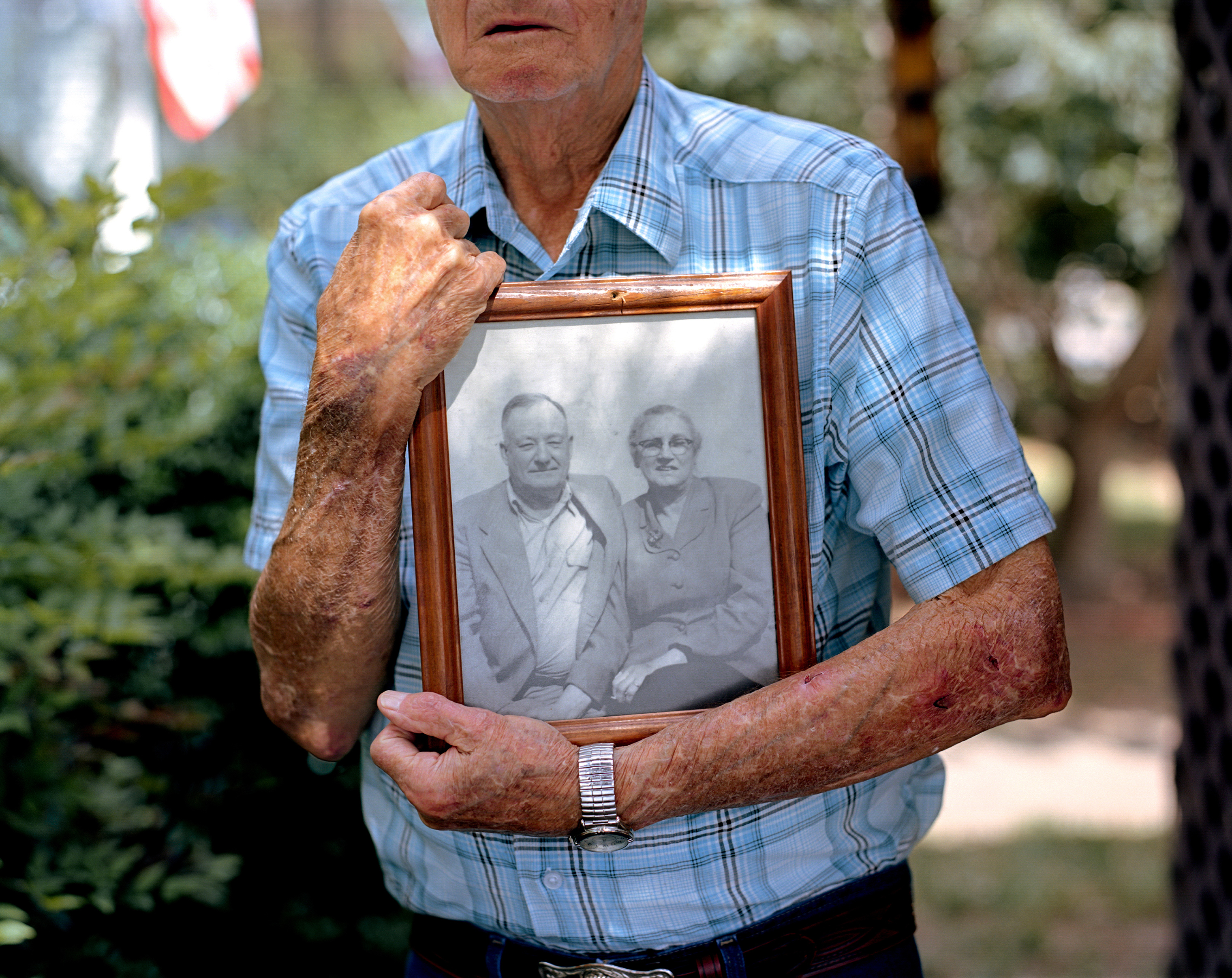 Gene Bowen holds a photograph of his parents at his home in LaGrange, Ga. Bowen was six years old when he awoke on a Sunday morning in 1940 to find his parents outside the home attending to a young African-American man, Austin Callaway, found bleeding to death on their property. The family wrapped the unconscious man in a bed sheet and rushed him to the local hospital, where he succumbed to his wounds. Callaway had been arrested the evening before. An armed group of hooded men snatched him from police custody without resistance, drove him to the edge of town, shot him multiple times and had left him to die. (Johnathon Kelso)