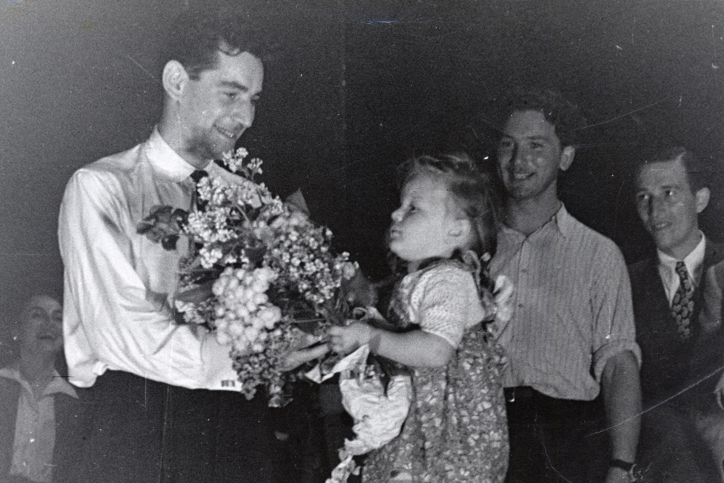 Leonard Bernstein receives flowers from an admirer after conducting an orchestra of concentration camp survivors for a concert sponsored by the American Jewish Joint Distribution Committee on May 10, 1948, outside Munich. (American Jewish Joint Distribution Committee)