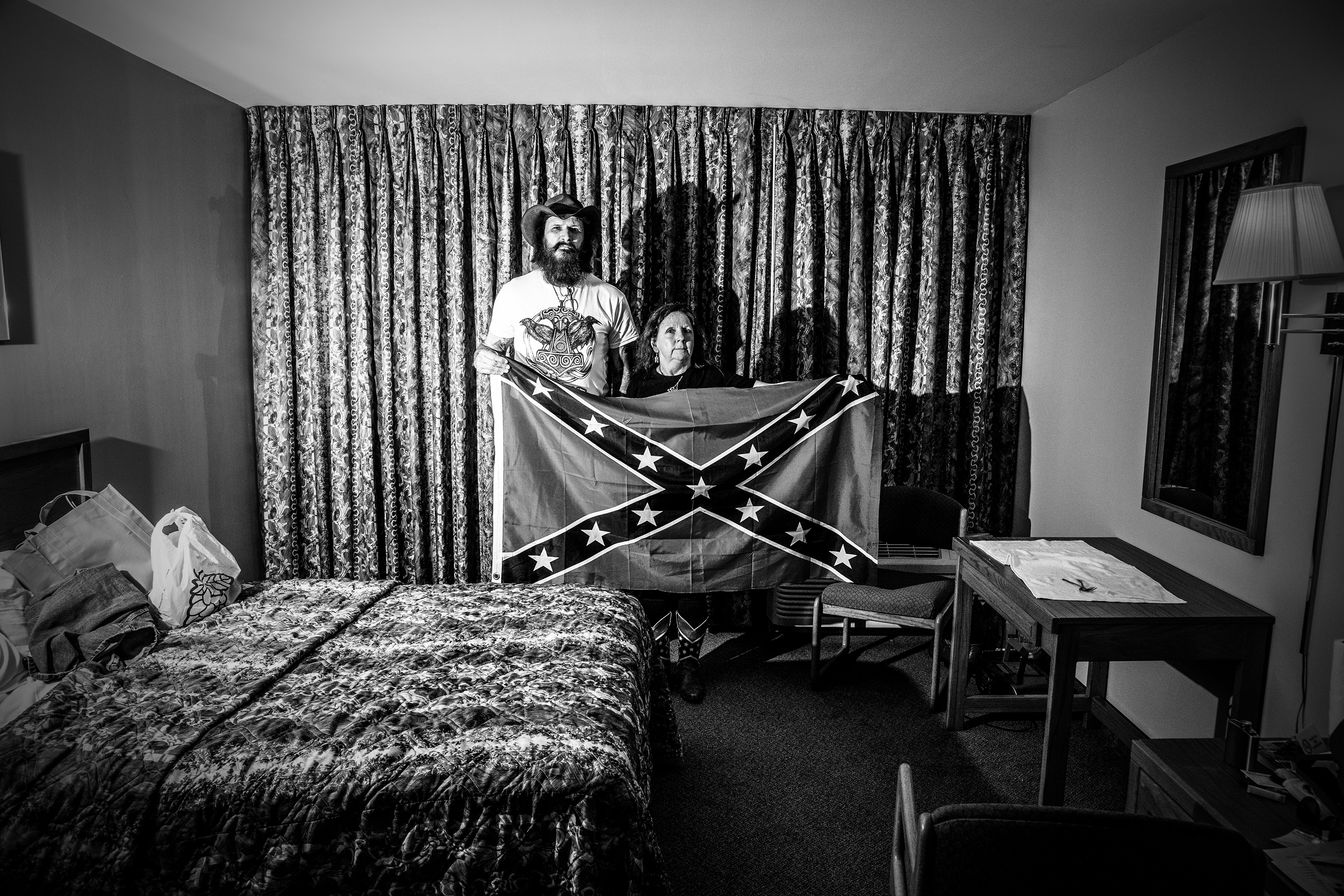 Mr. and Mrs. McDonald pose with a Confederate flag in their hotel room while attending the American Freedom Party and Council of Conservative Citizens conference in Nashville, a conference attended by white nationalist supporters and white supremacists, on June 16, 2018. (Mark Peterson—Redux)