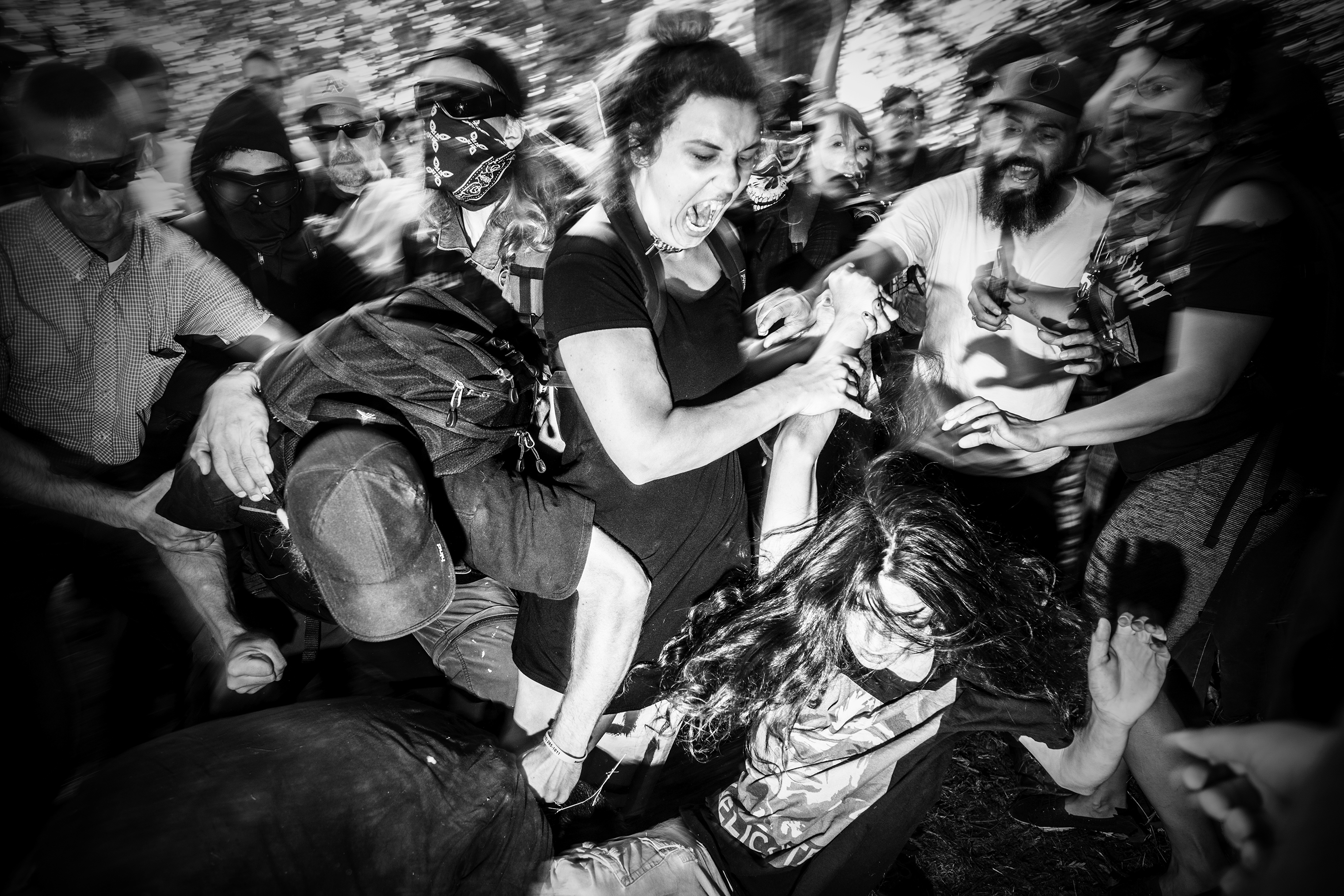 A man wearing a Trump t-shirt is attacked by members of Antifa during a cancelled 'No to Marxism' rally in Berkeley, Calif., on Aug. 27, 2017. (Mark Peterson—Redux)
