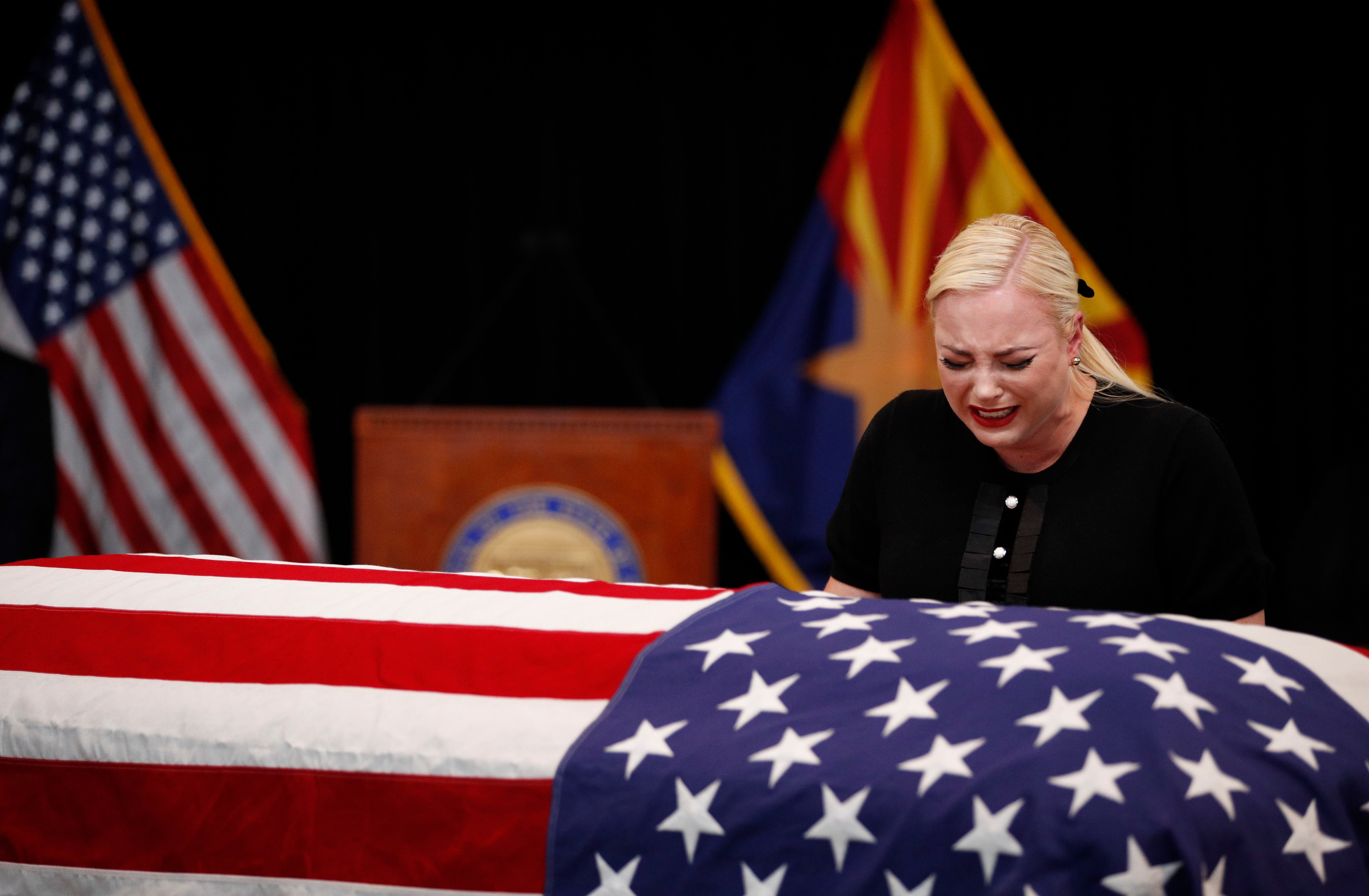 Meghan McCain, daughter of Sen. John McCain, touches the casket during a memorial service at the Arizona Capitol on August 29, 2018, in Phoenix, Arizona. John McCain will lie in state at the Arizona State Capitol before being transported to Washington D.C. where he will be buried at the U.S. Naval Academy Cemetery in Annapolis. Sen. McCain, a decorated war hero, died August 25 at the age of 81 after a long battle with Glioblastoma, a form of brain cancer. (Jae C. Hong - Pool/Getty Images)