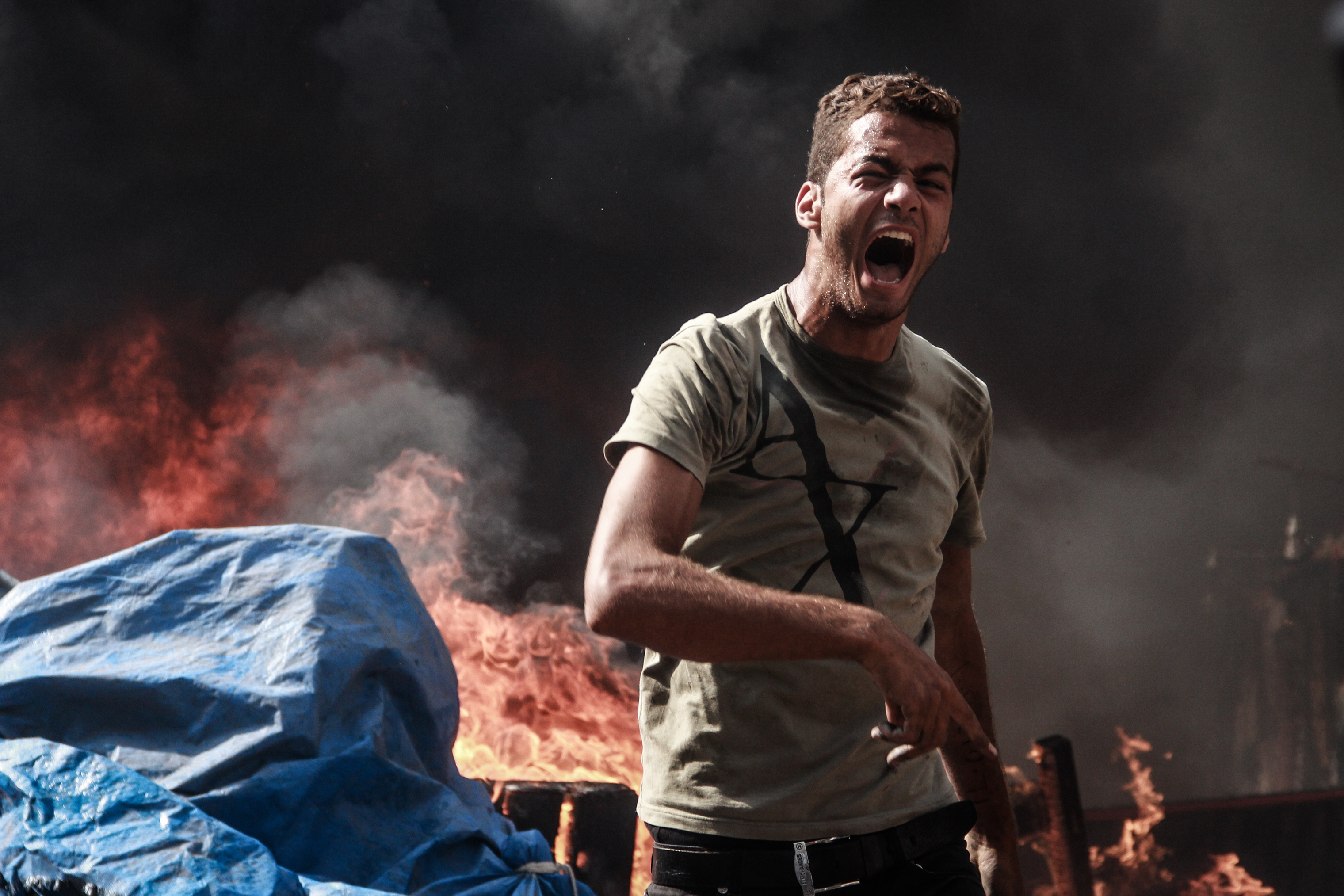 A man yells in the burning ruins of the square. (Mosa’ab Elshamy)
