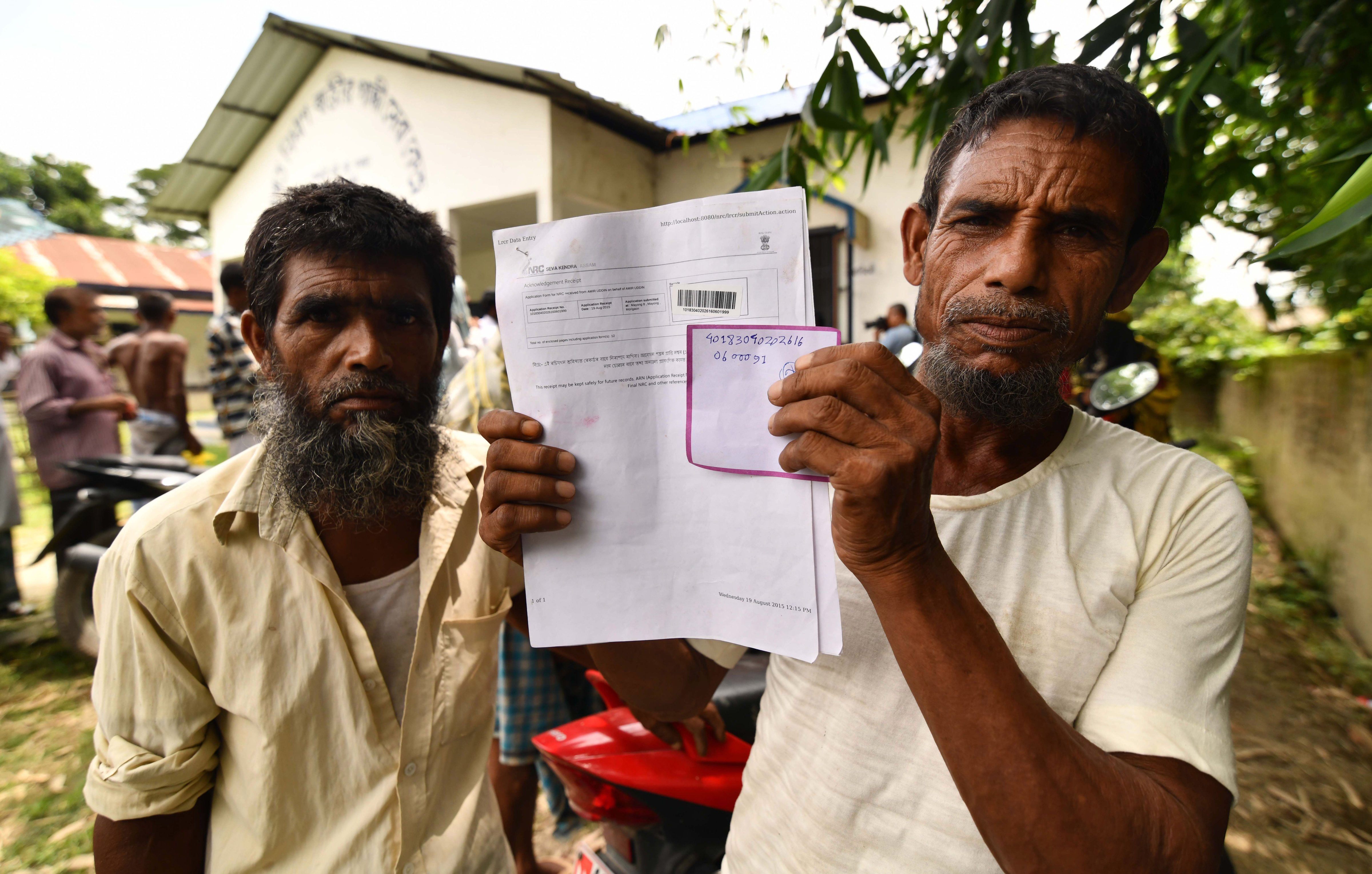 A resident holds documents on his way to check their names on the final list of National Register of Citizens (NRC) at a NRC Sewa Kendra (NSK) in Kuranibori village in Morigoan district on July 30, 2018. (Biju Boro—AFP/Getty Images)