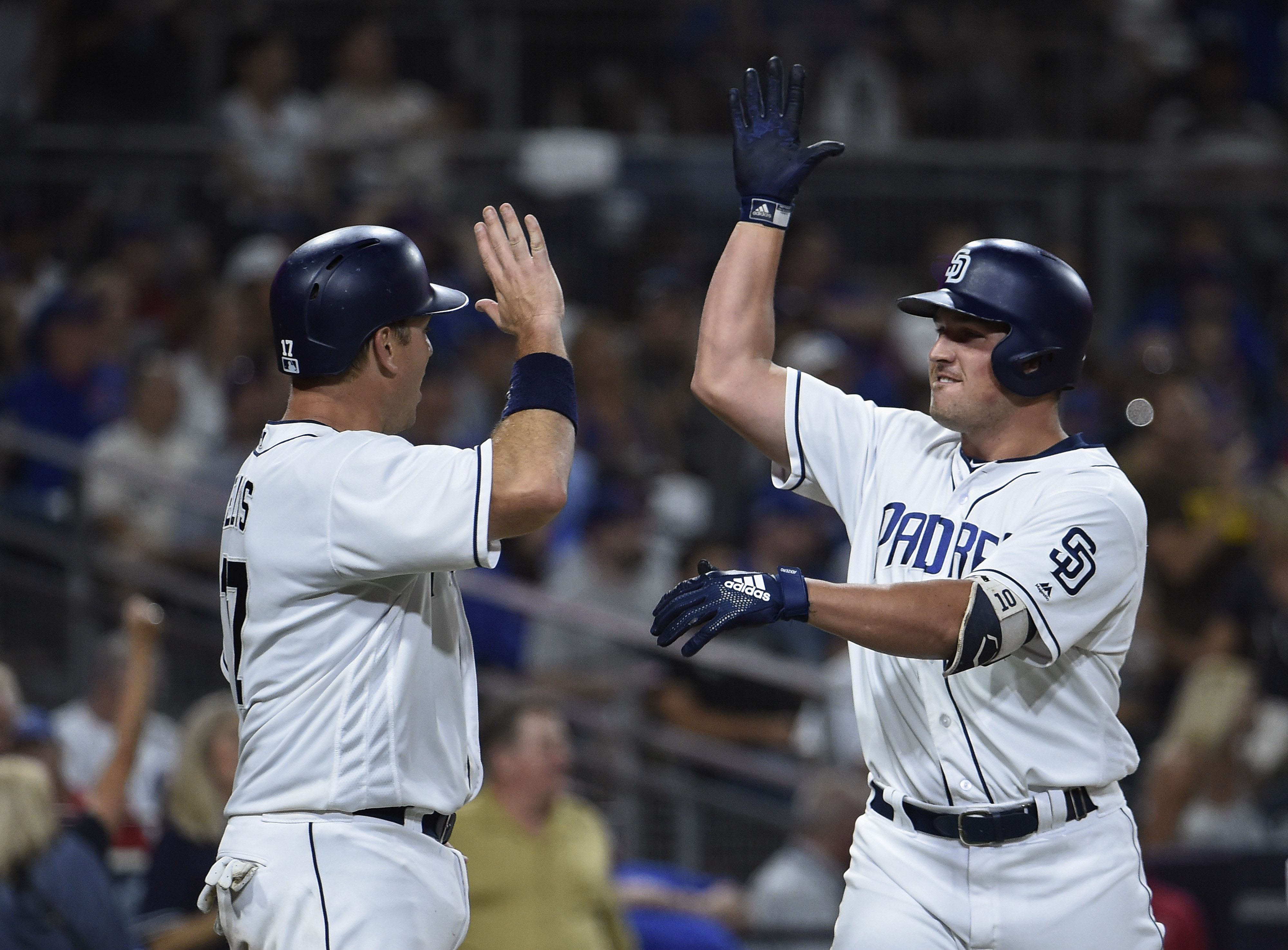 Hunter Renfroe #10 of the San Diego Padres is congratulated by A.J. Ellis #17 after hitting a two-run home run during the seventh inning of a baseball game against the San Diego Padres at PETCO Park on July 14, 2018 in San Diego, California. (Denis Poroy&mdash;Getty Images)