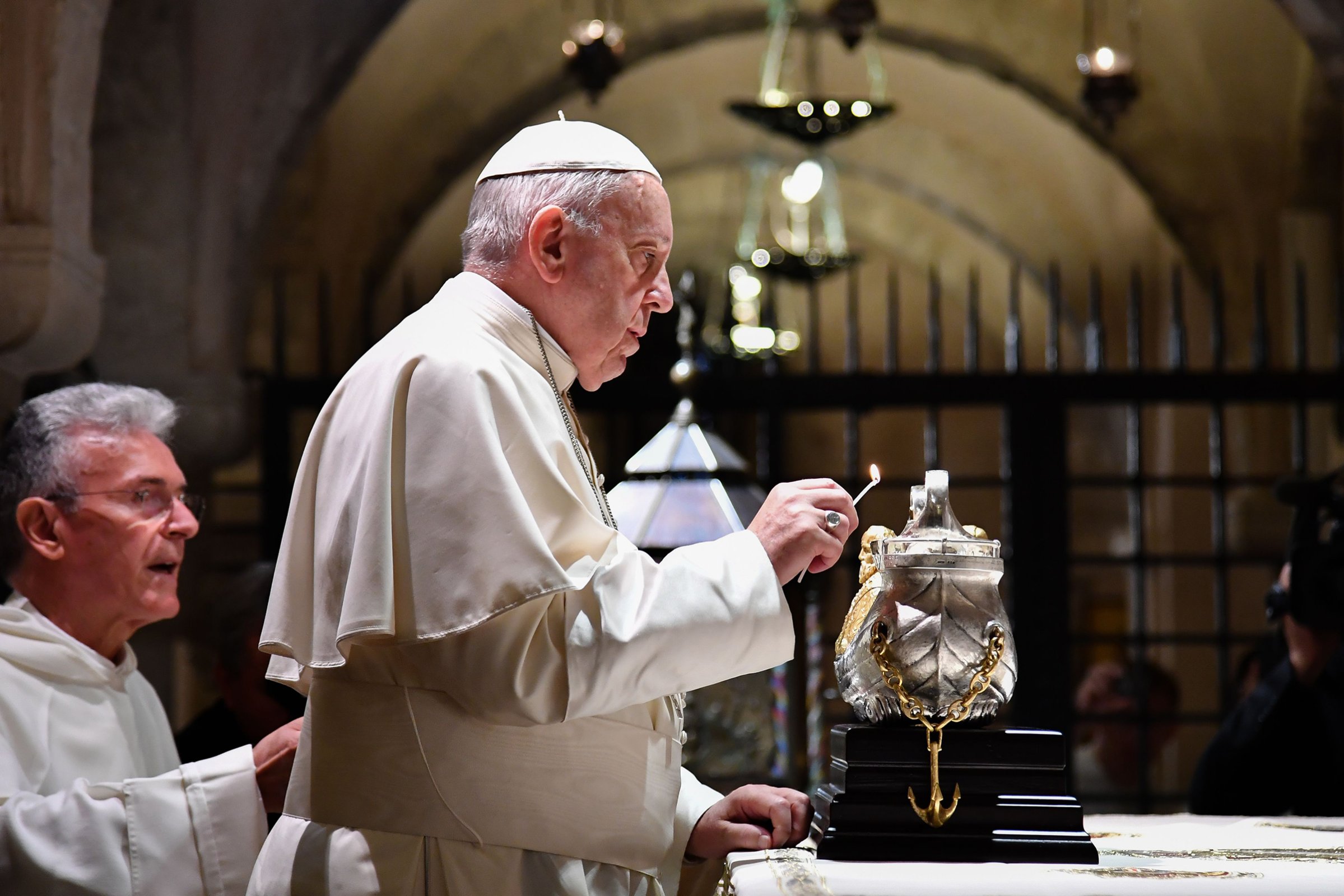 Pope Francis lights the uniflamma lamp at the tomb of Saint Nicholas in Pontifical Basilica of St Nicholas in Bari, Italy, on July 7, 2018.