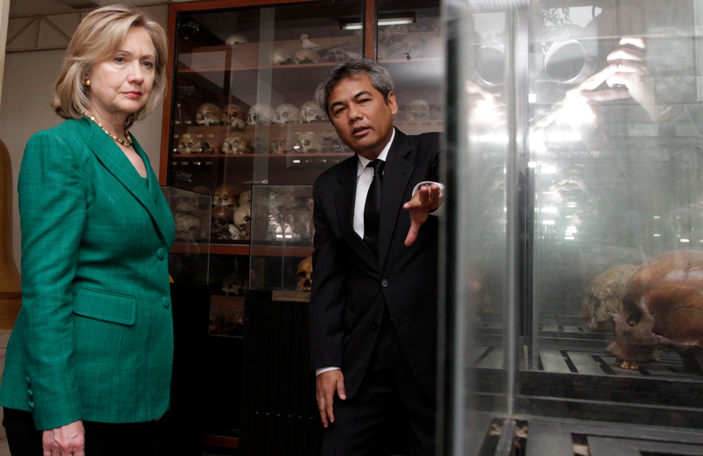 U.S. Secretary of State Clinton listens to Youk Chhang, director of the Documentation Center of Cambodia, in Phnom Penh