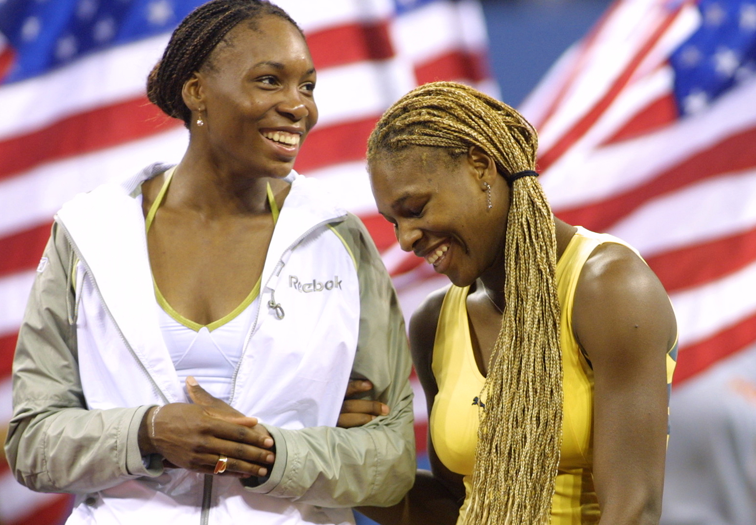 Venus Williams and Serena Williams share a laugh. Venus defeats her sister Serena, 6-2, 6-4 to win U.S. Open. (Cynthia Lum—Getty Images)