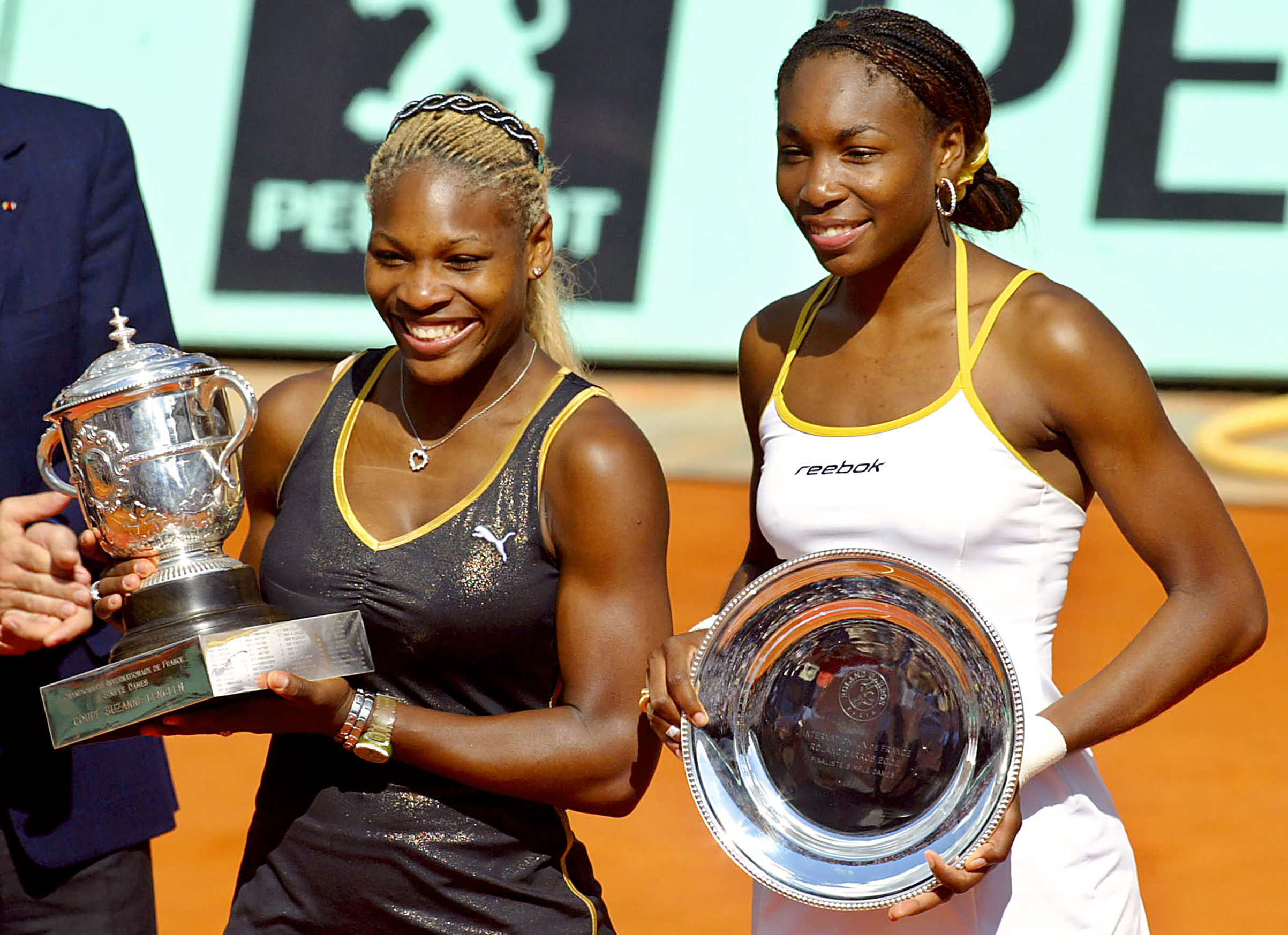 US Serena Williams (L) and her sister and opponent Venus Williams hold Roland Garros trophies, Jun 8, 2002 in Paris, at the end of the Roland Garros French Open women's final match. Serena won 7-5, 6-3. (ANDRE DURAND—AFP/Getty Images)