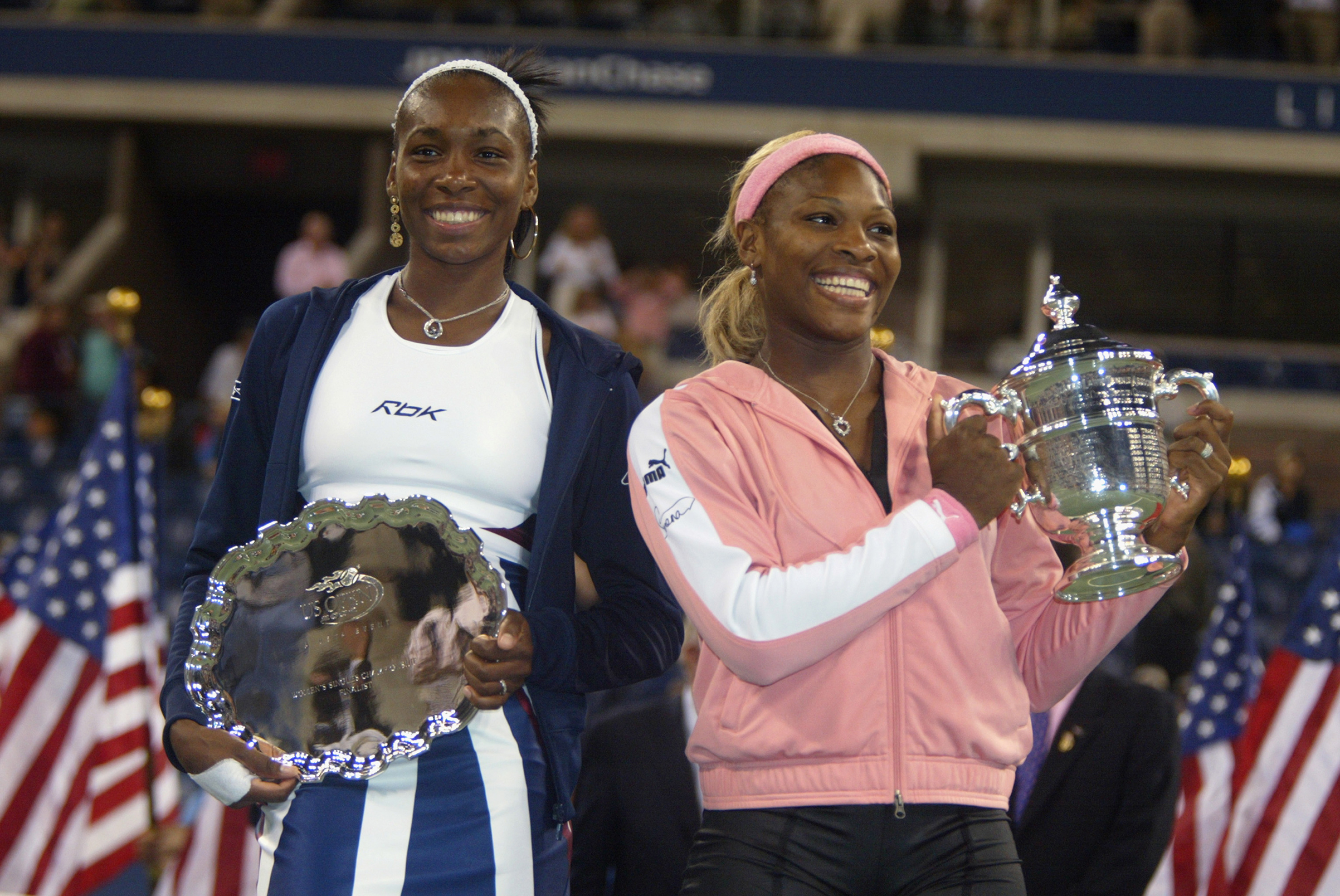 Venus Williams (L) of the USA and Serena Williams of the USA pose for photographers after the women's final of the US Open at the USTA National Tennis Center on September 7, 2002 in Flushing Meadows-Corona Park, New York. Serena Williams defeated her sister and won the US Open. (Al Bello—Getty Images)