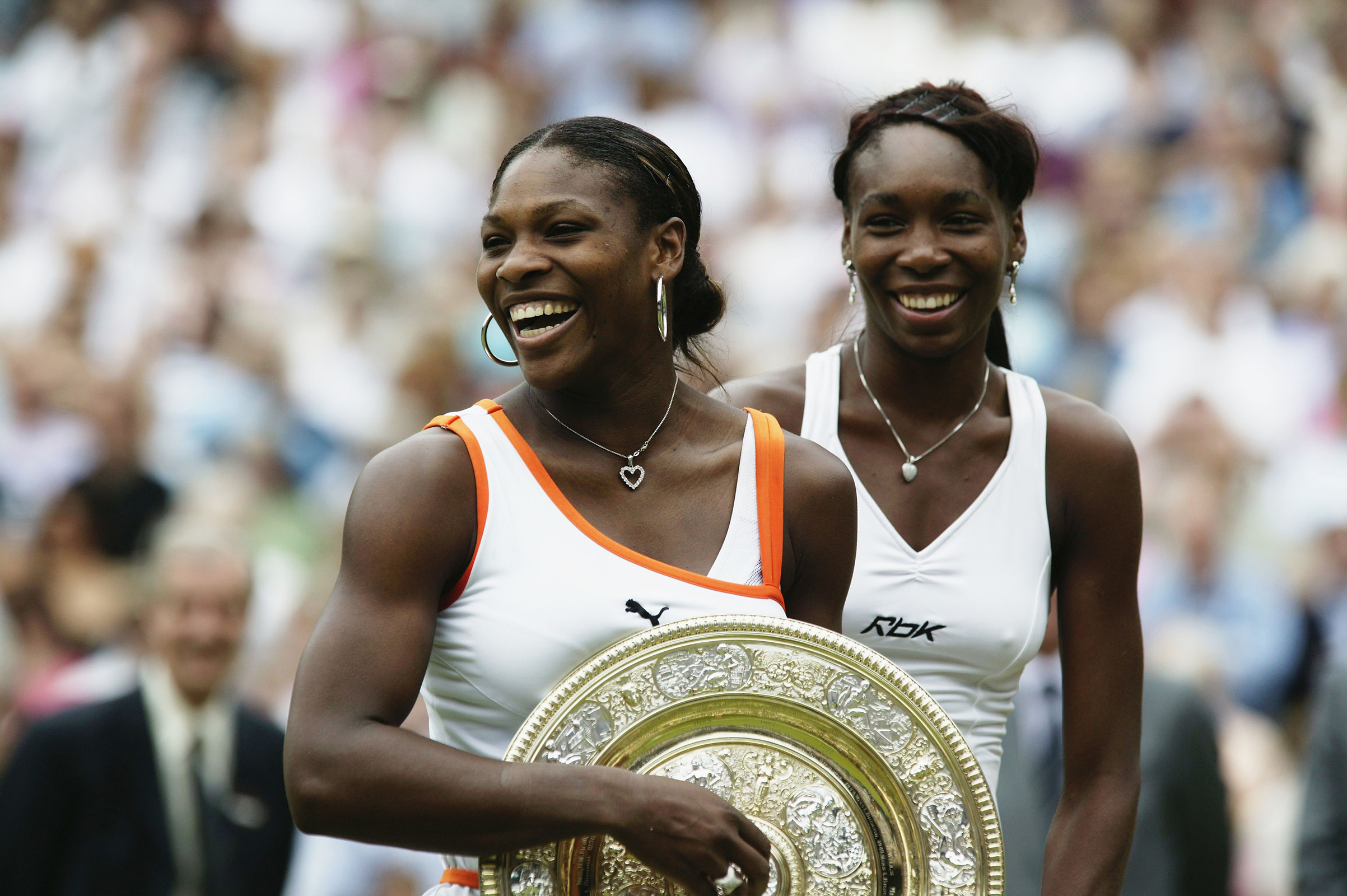 Serena Williams (L) of the USA holding the trophy after her match against sister Venus Williams of the USA in the Womens Singles Final during day twelve of the Wimbledon Lawn Tennis Championships held on July 5, 2003 at the All England Lawn Tennis and Croquet Club, in Wimbledon, London. (Alex Livesey—Getty Images)