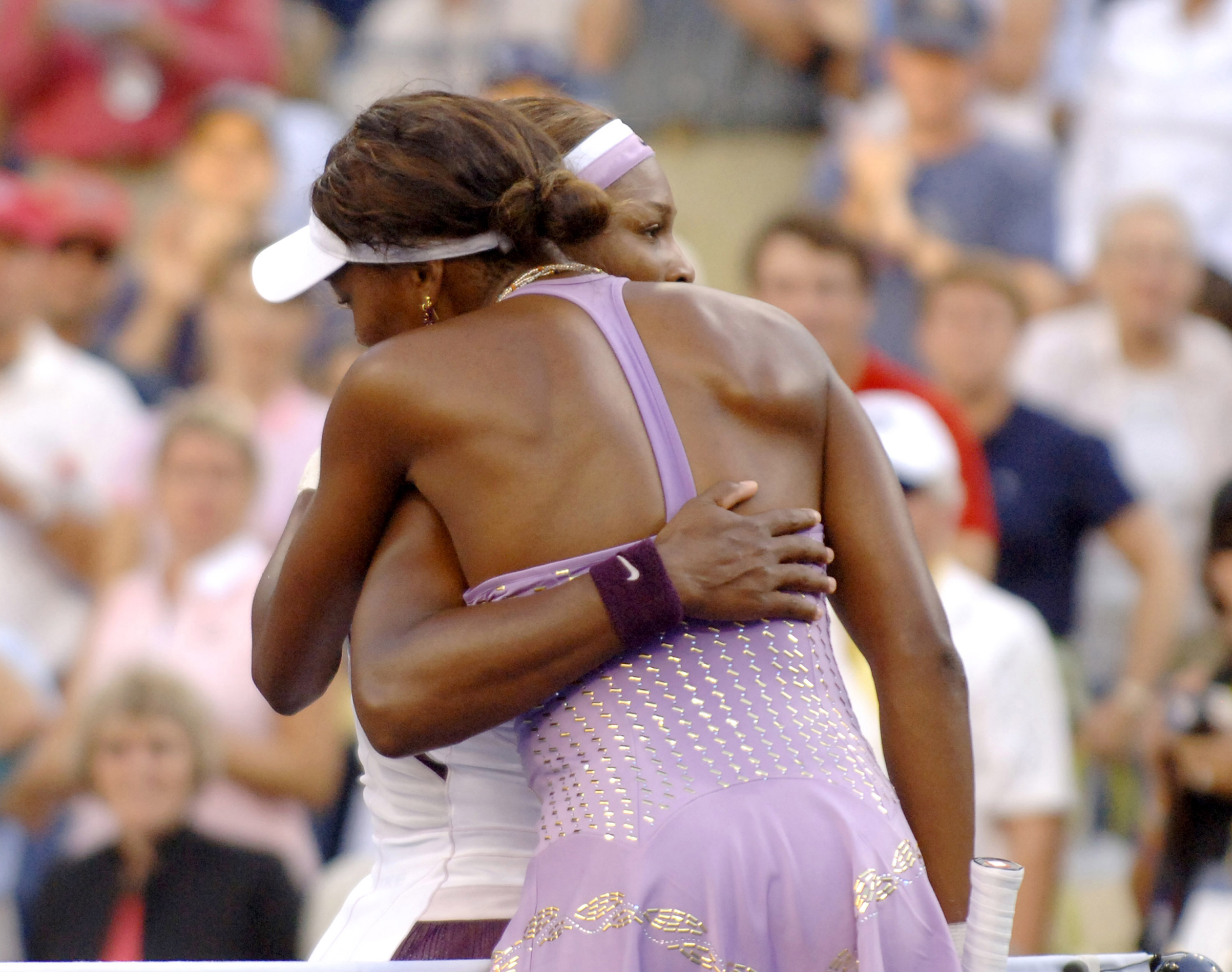 Serena Williams hugs her sister, Venus, after play in a 7-6 6-2 women's quarter final match at the 2005 U. S. Open in Flushing, New York. (Al Messerschmidt—WireImage)